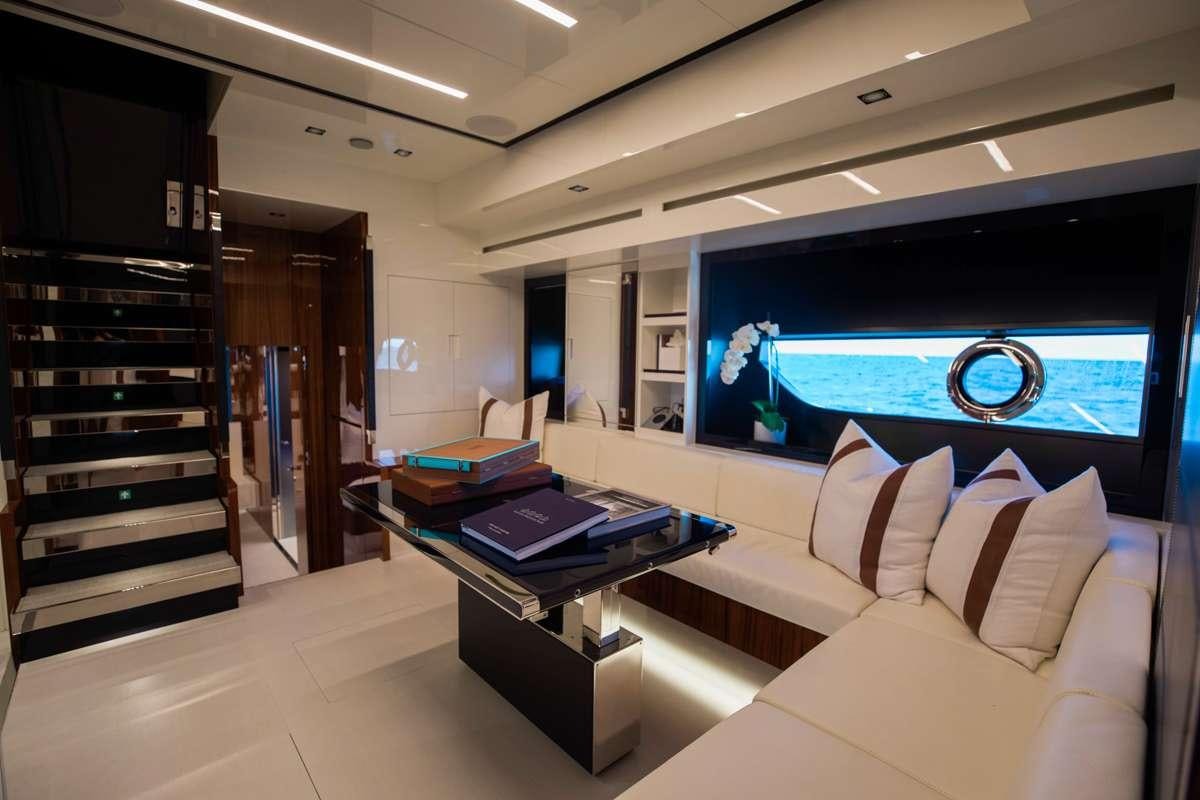 a room with a couch and a tv aboard NOT YET Yacht for Charter