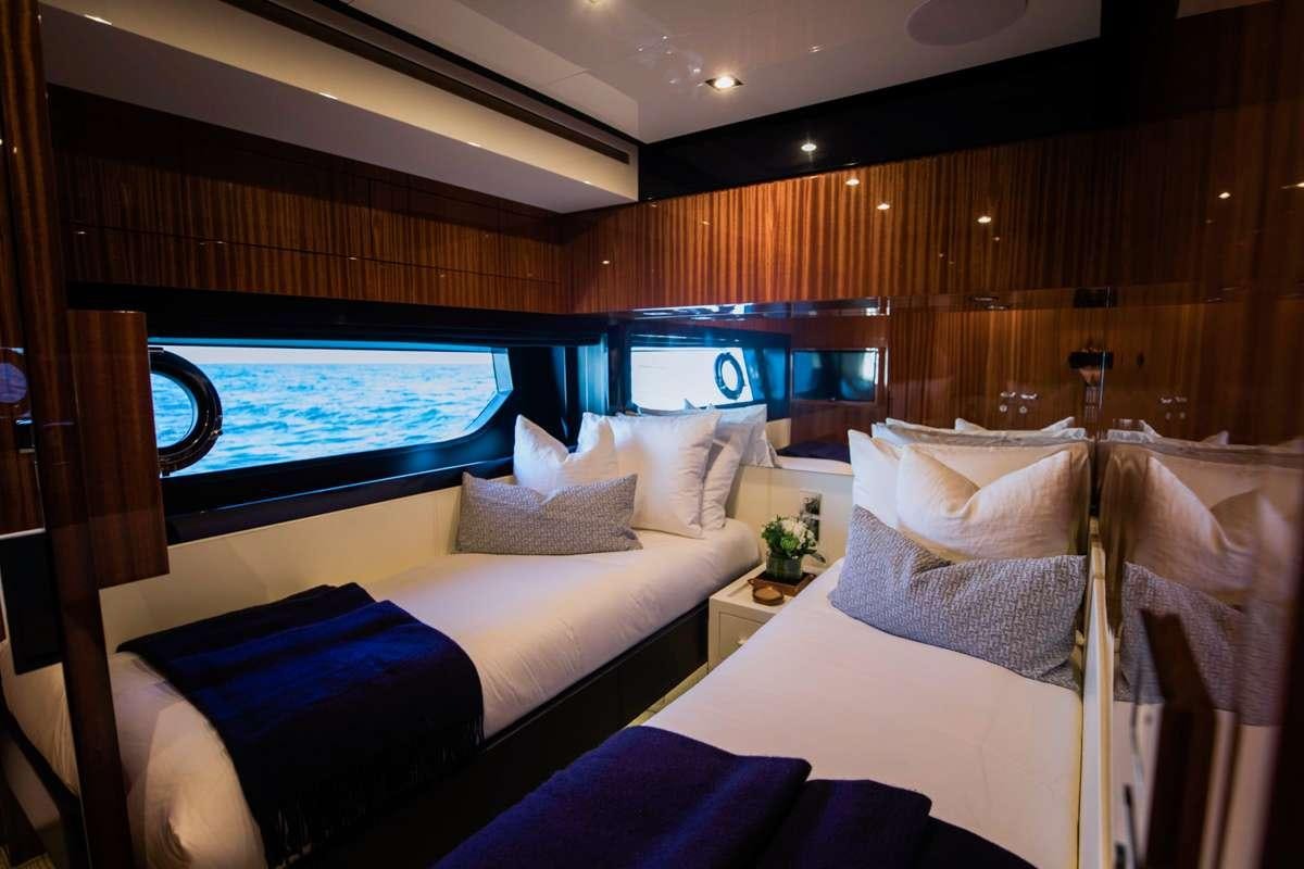 a room with a bed and a window aboard NOT YET Yacht for Charter