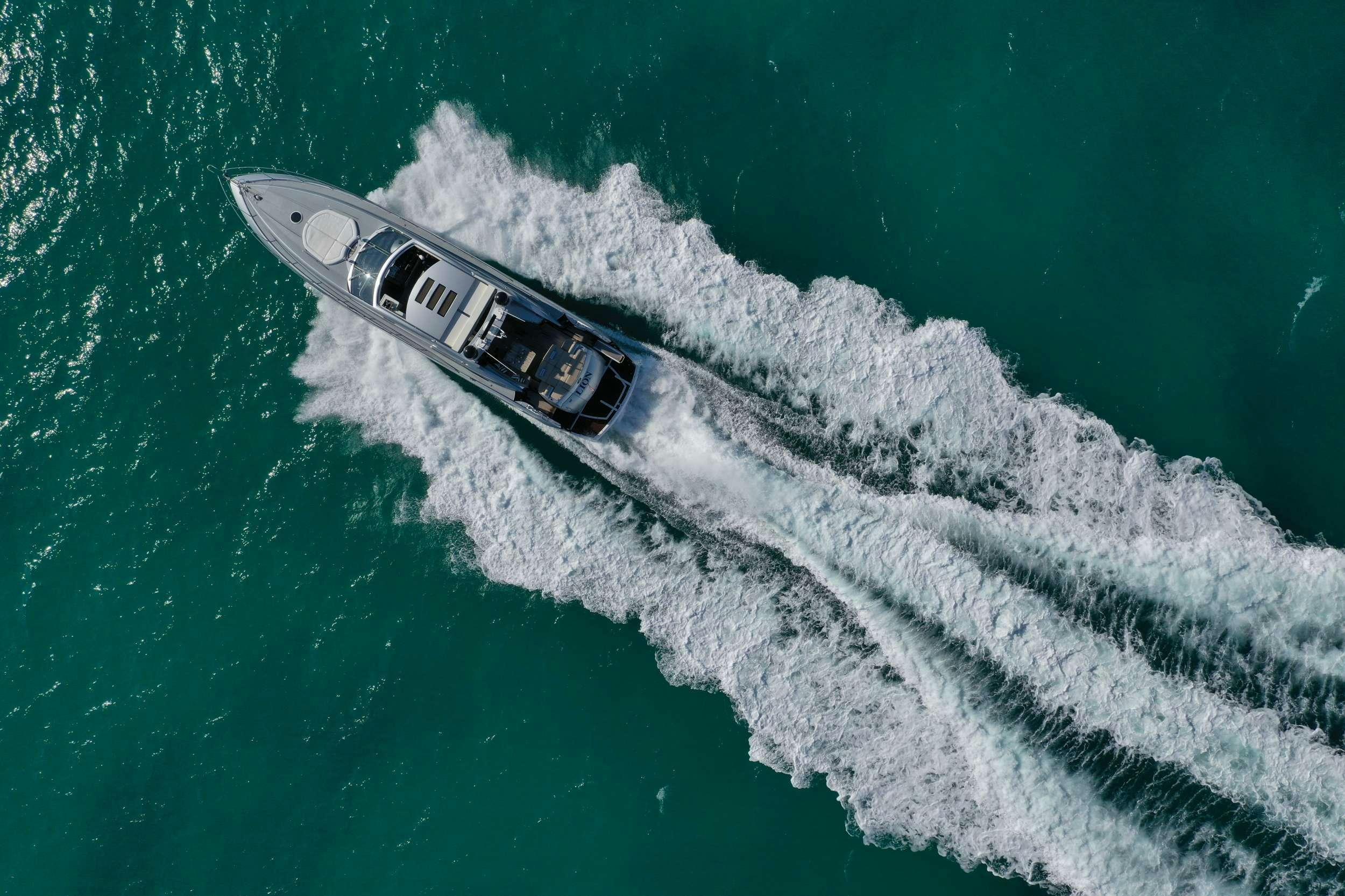a helicopter flying over a sea aboard LION Yacht for Charter