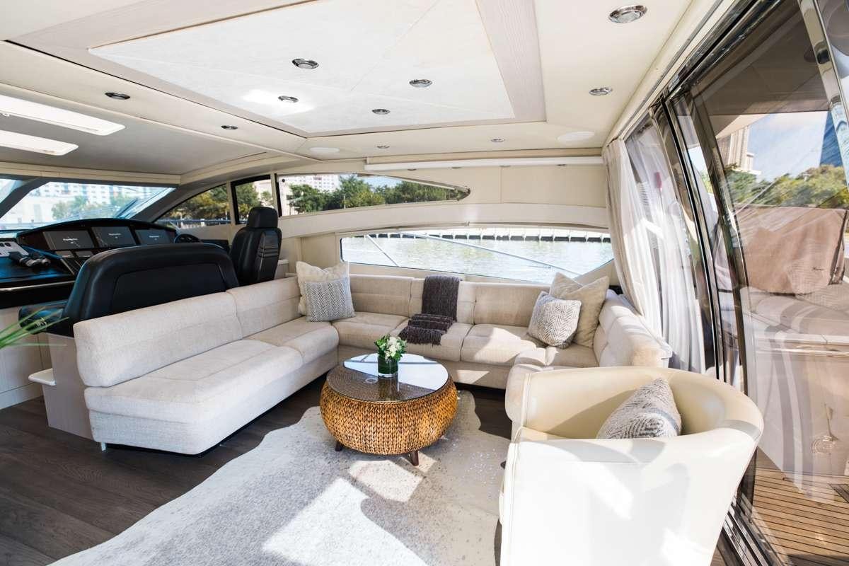 a car with a couch and a table in the middle aboard LION Yacht for Charter