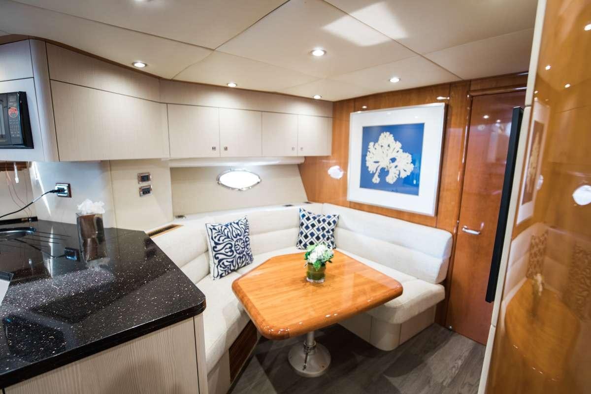 a kitchen with a table and chairs aboard LION Yacht for Charter