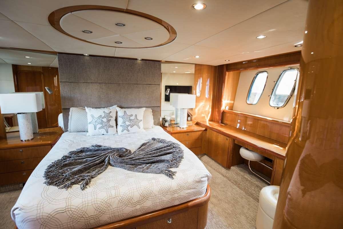 a bedroom with a bed and a mirror aboard LION Yacht for Charter