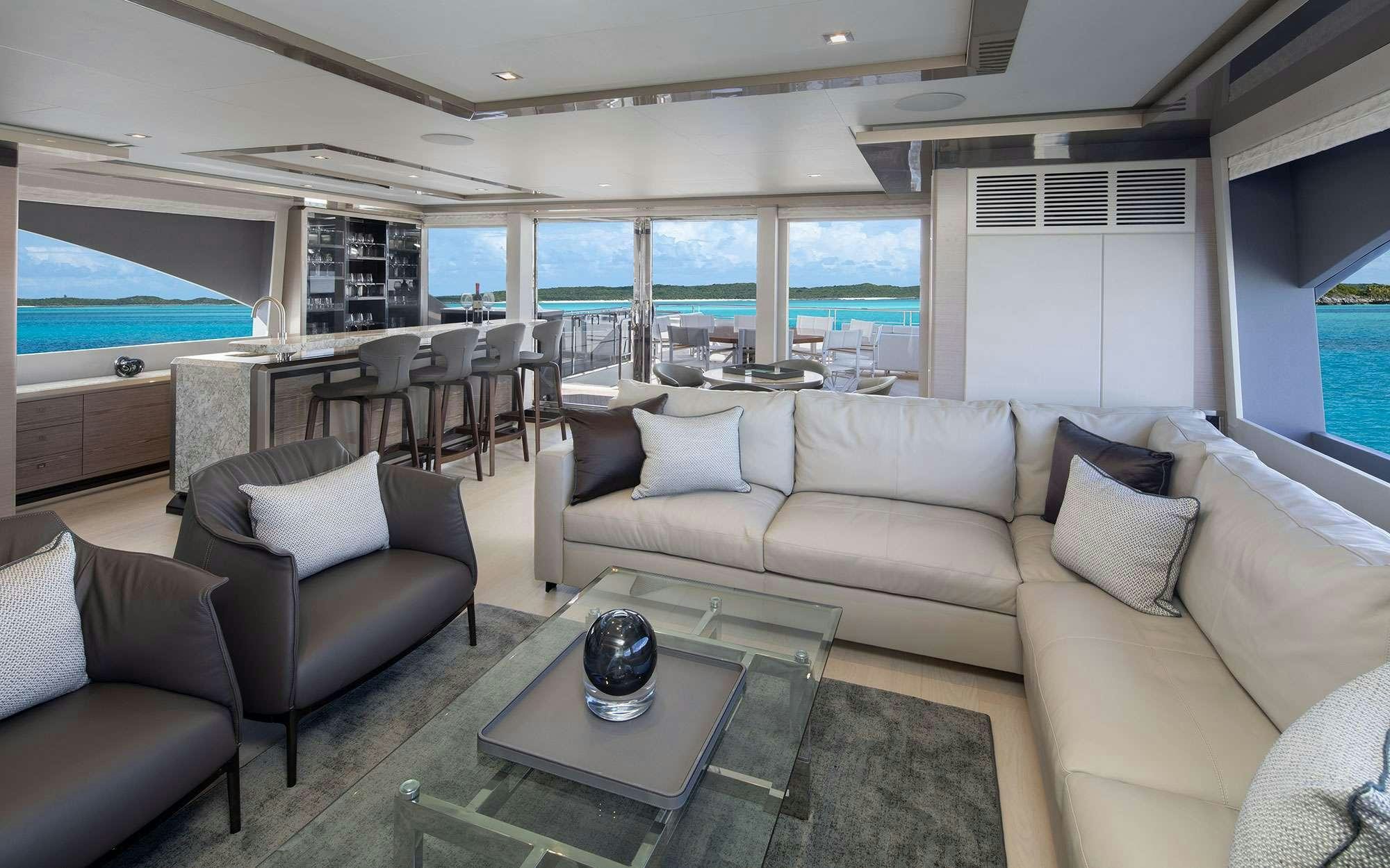 a living room with a large window aboard DREAMS Yacht for Charter
