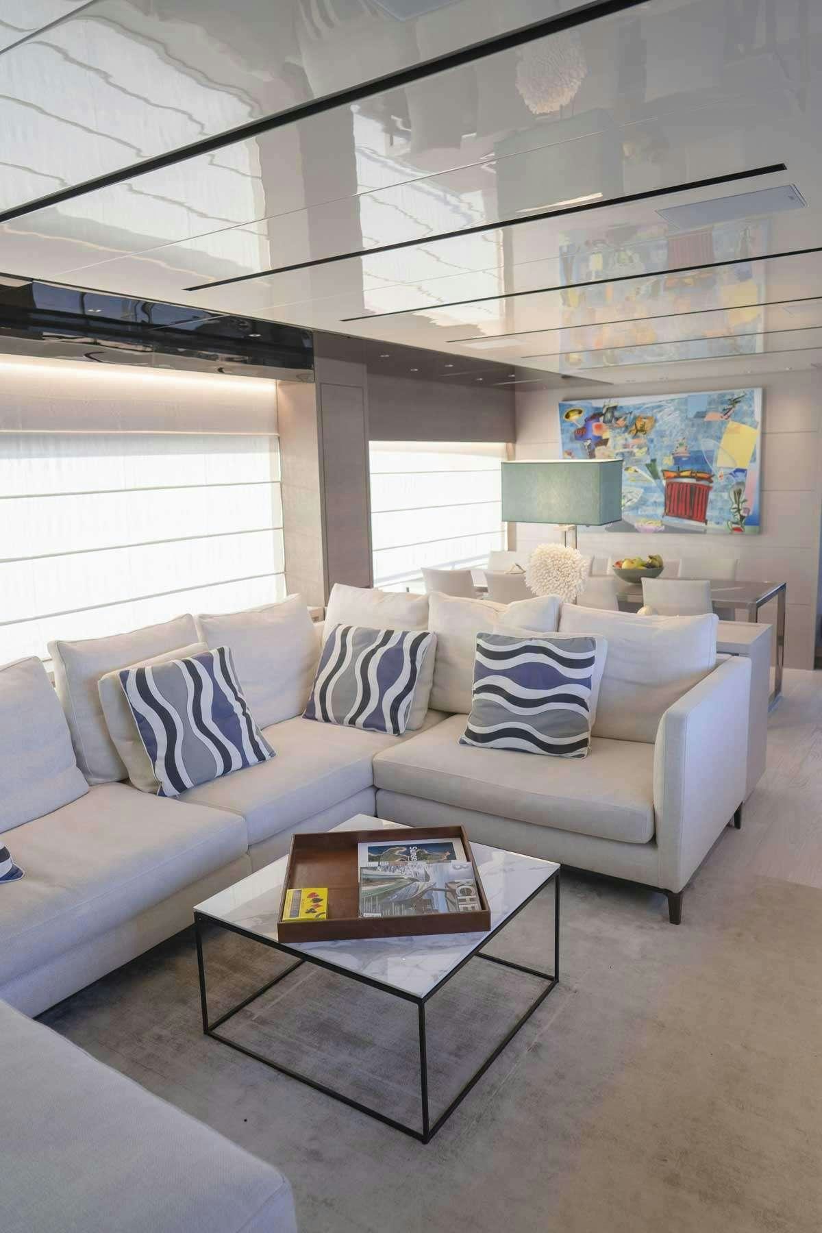 a living room with a couch and a coffee table aboard EM3 Yacht for Charter