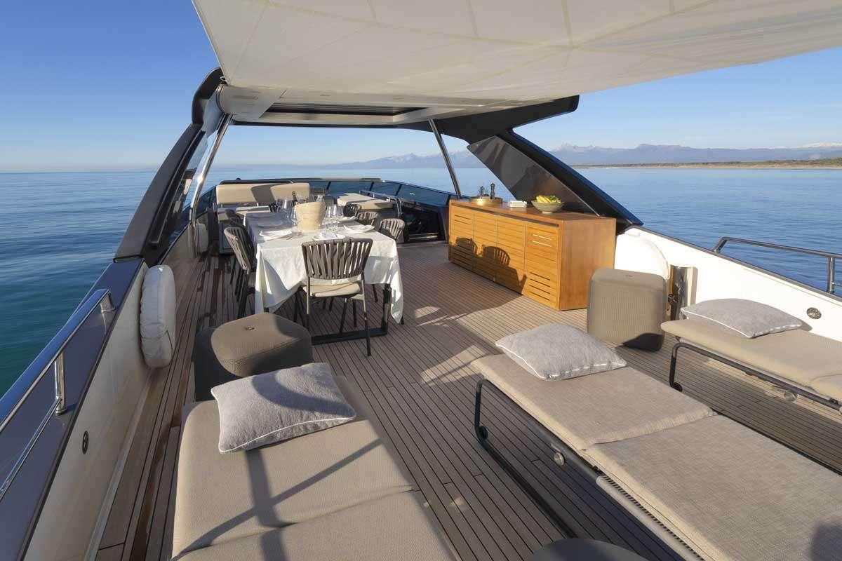 a boat with a bed and a table on the deck aboard EM3 Yacht for Charter