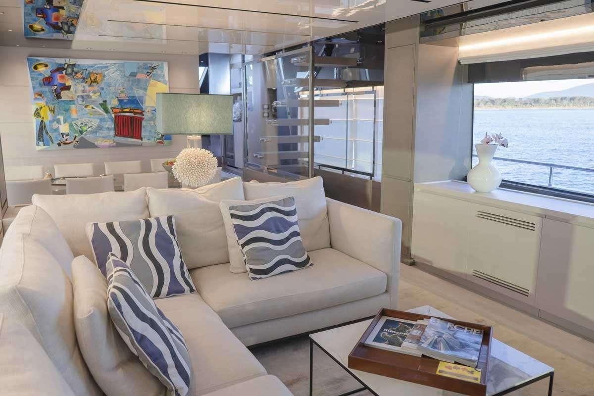 a living room with a couch and a table aboard EM3 Yacht for Charter