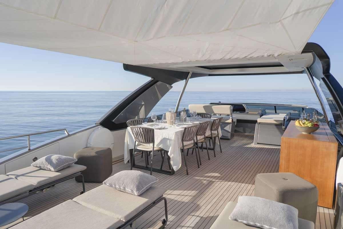 a room with a bed and a table and chairs aboard EM3 Yacht for Charter