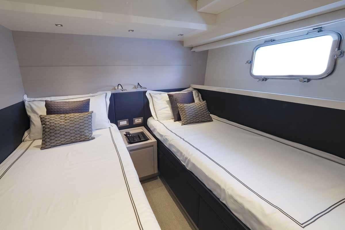a couple of beds in a room aboard EM3 Yacht for Charter