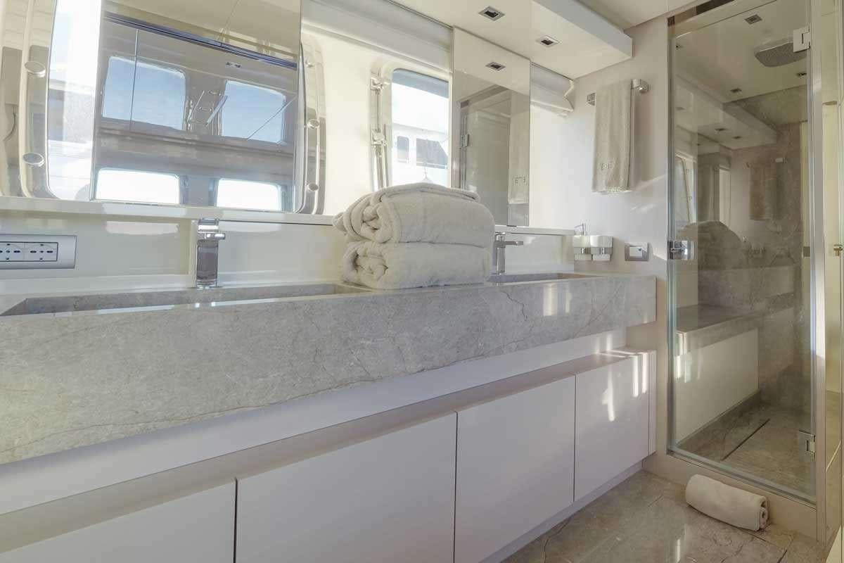 a large bathroom with a large counter aboard EM3 Yacht for Charter