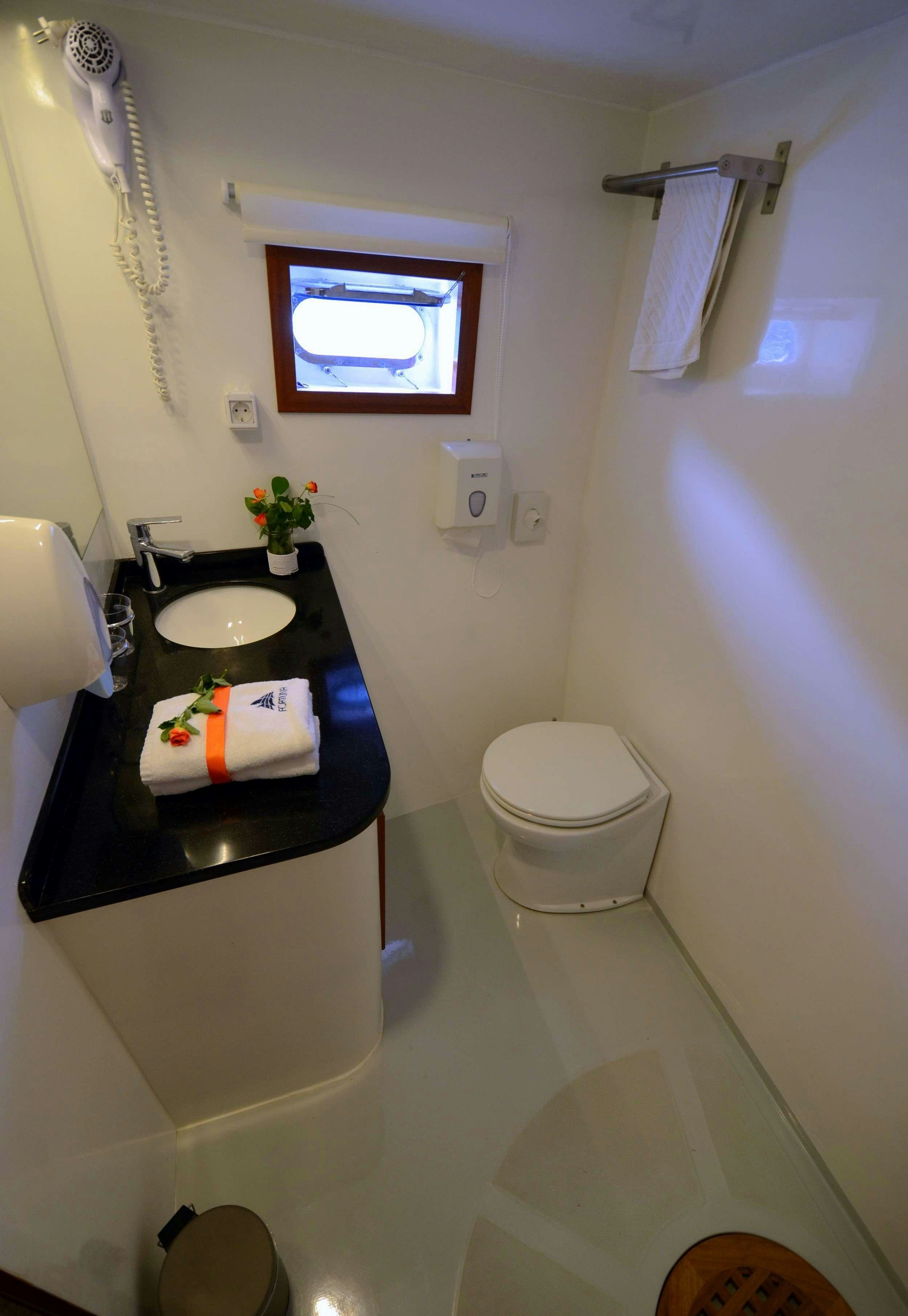 a bathroom with a sink and toilet aboard FORTUNA Yacht for Charter