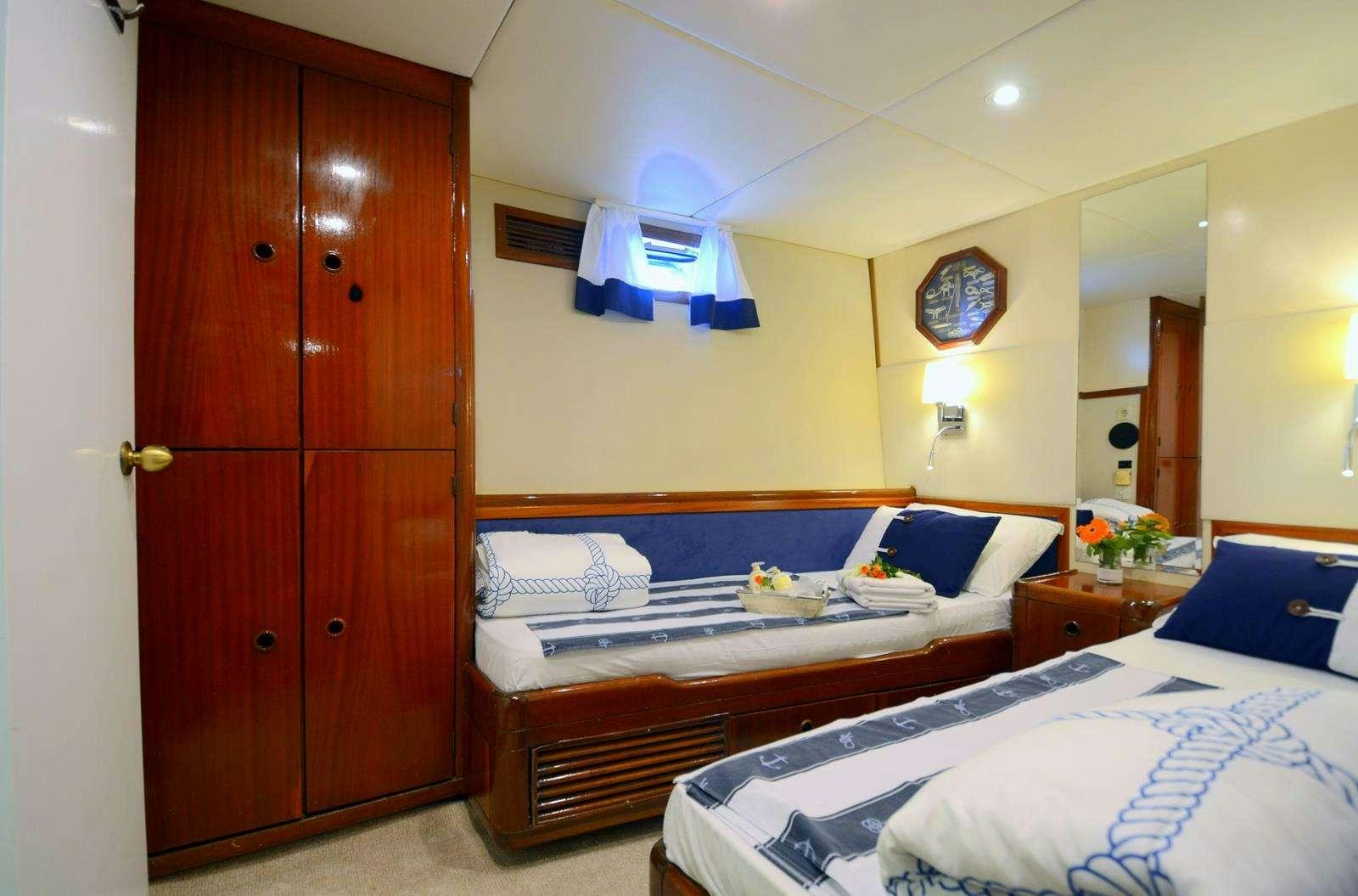 a bedroom with a couple beds aboard FORTUNA Yacht for Charter