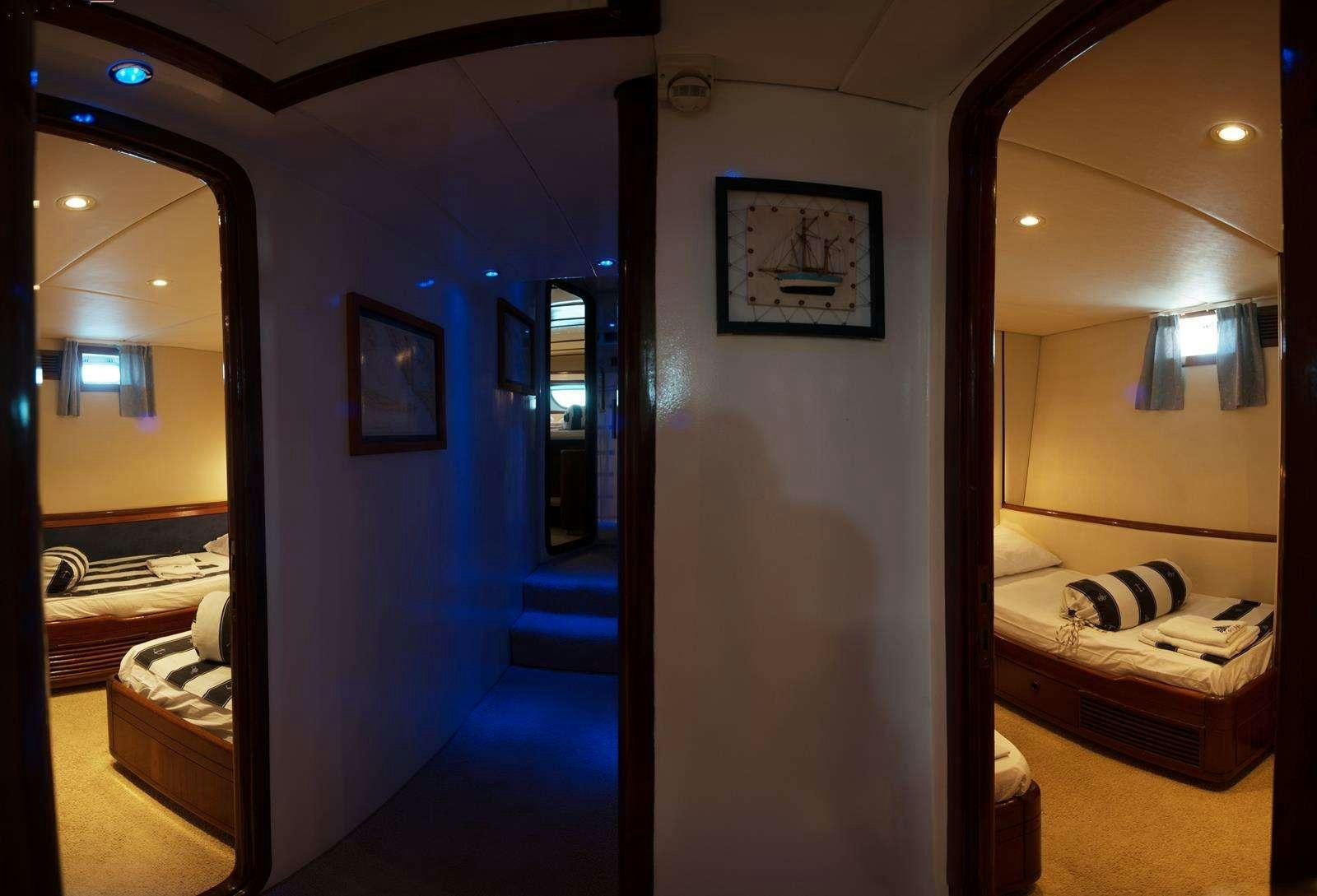 a room with a bed and a mirror aboard FORTUNA Yacht for Charter
