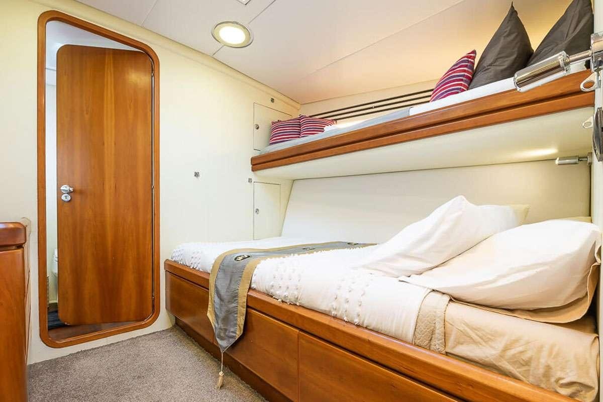 a room with two beds aboard OCEAN PHOENIX Yacht for Charter