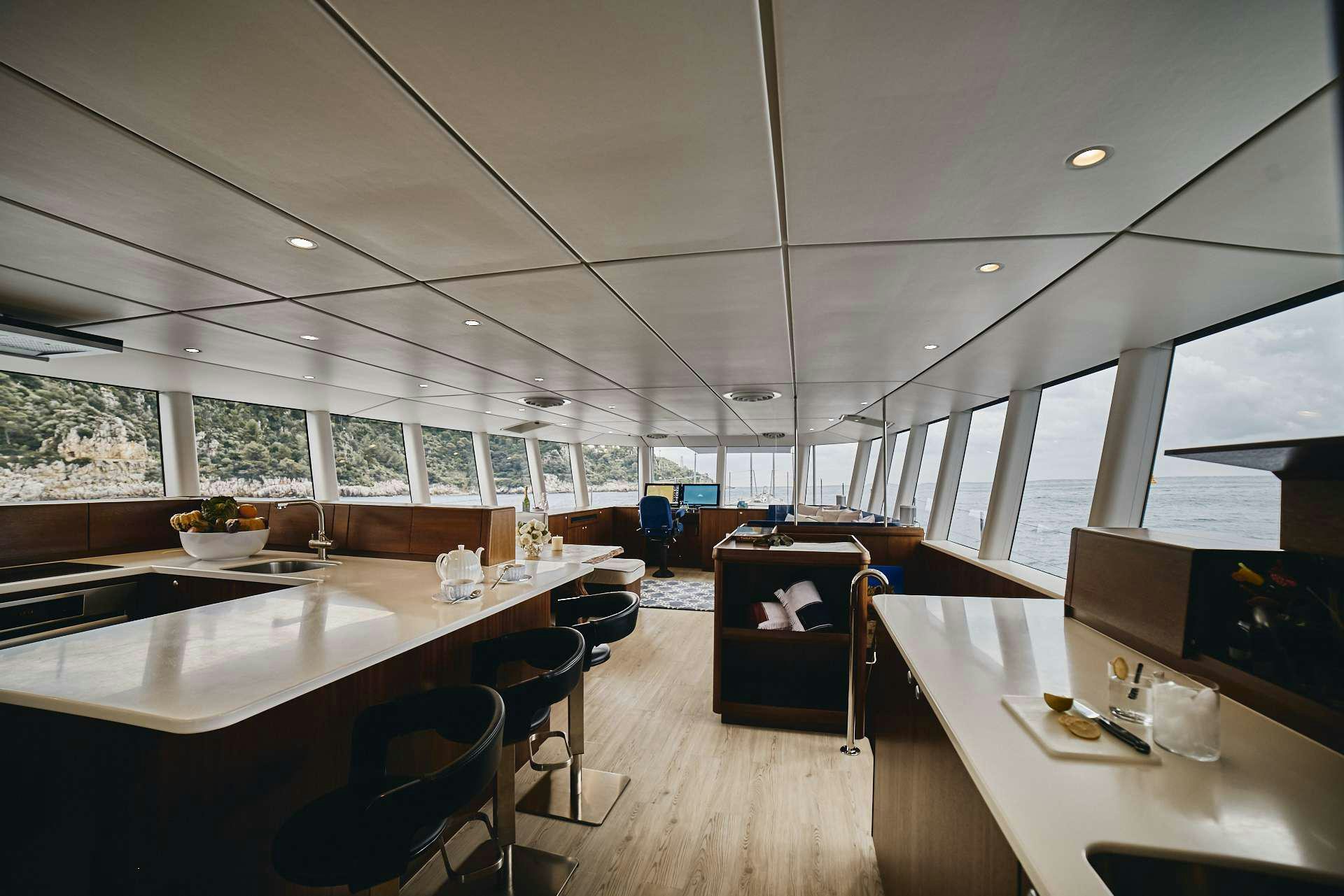 a room with tables and chairs aboard ICEBERG Yacht for Charter