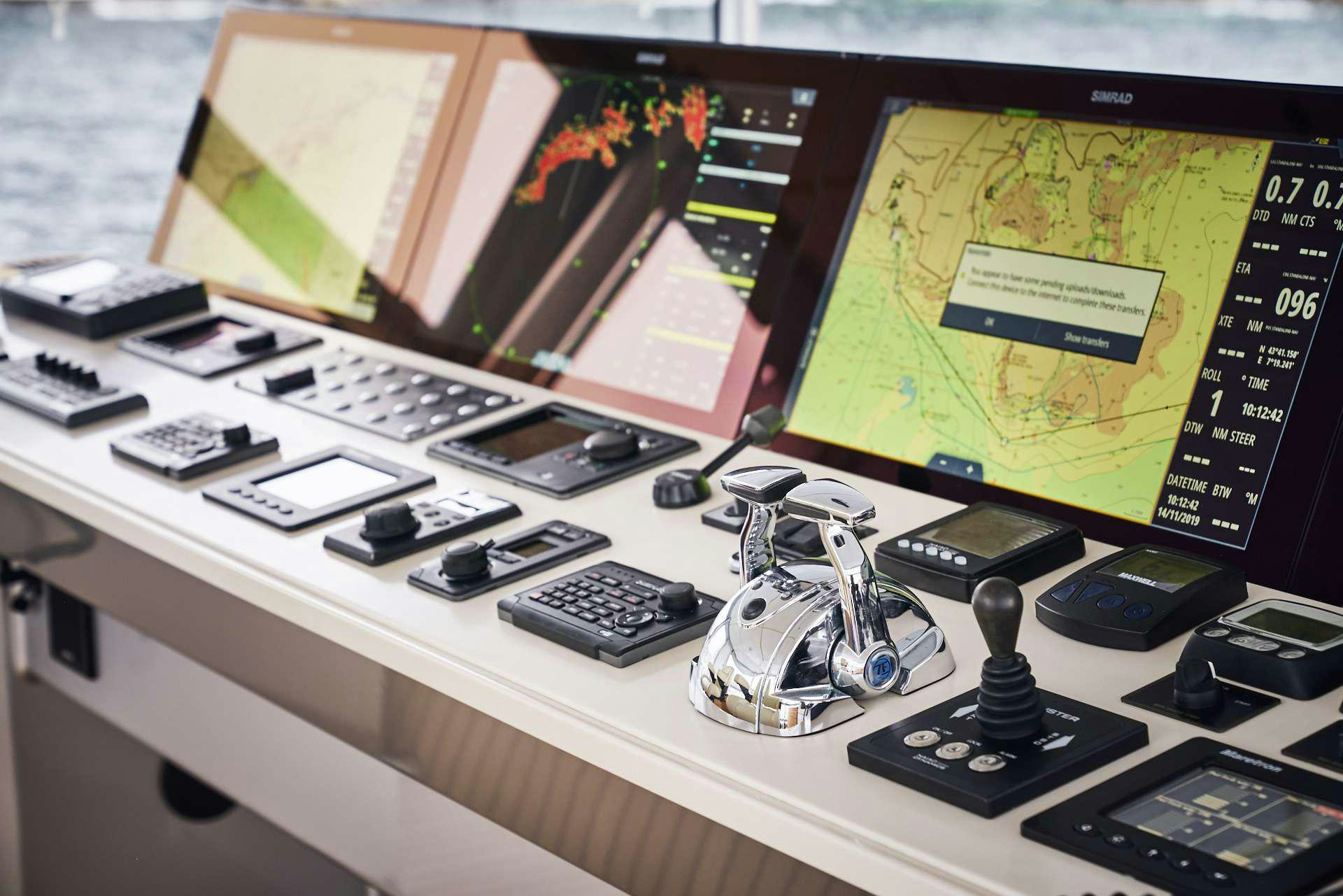 a desk with a computer and a couple of monitors aboard ICEBERG Yacht for Charter
