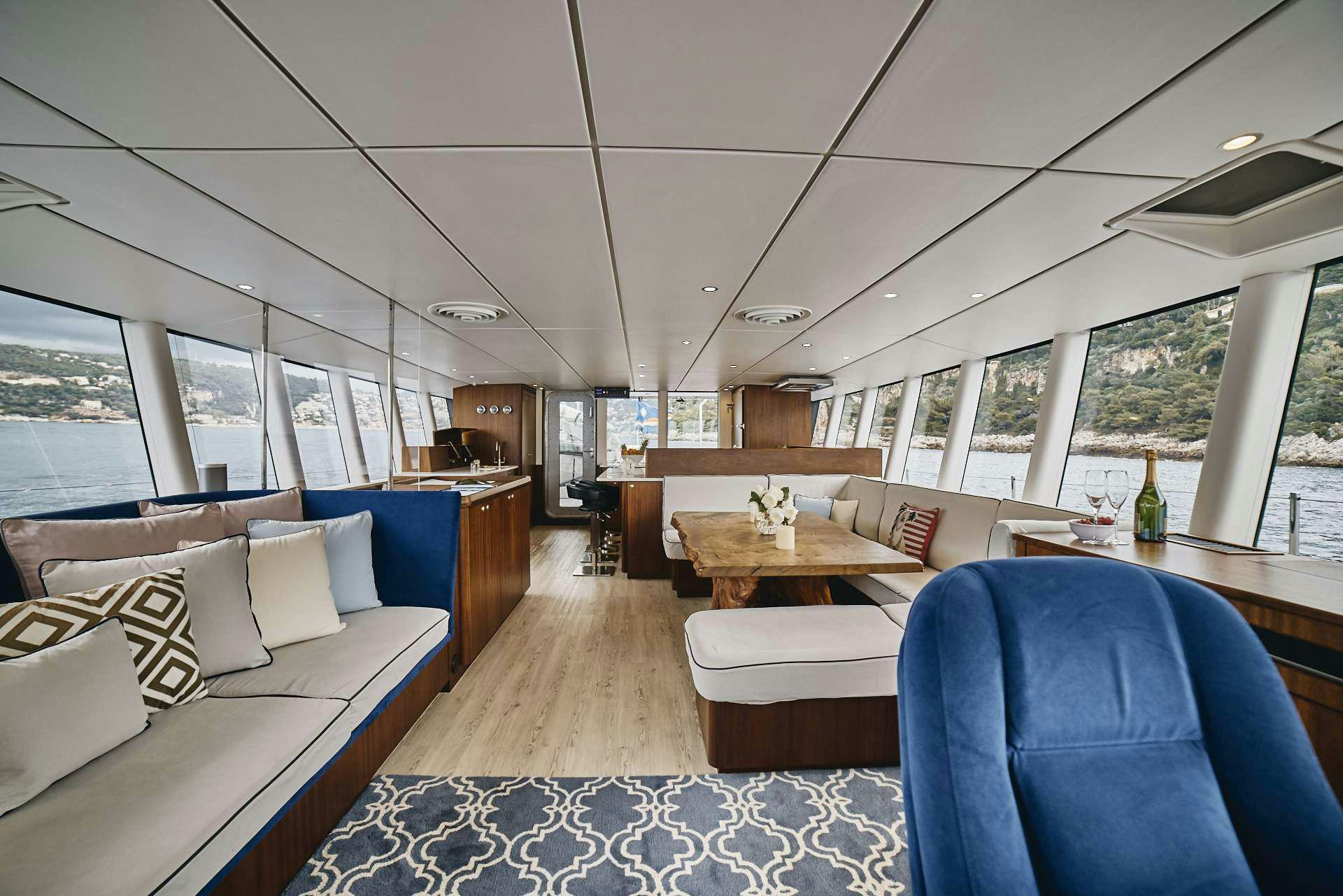 a room with a couch and a table and chairs aboard ICEBERG Yacht for Charter