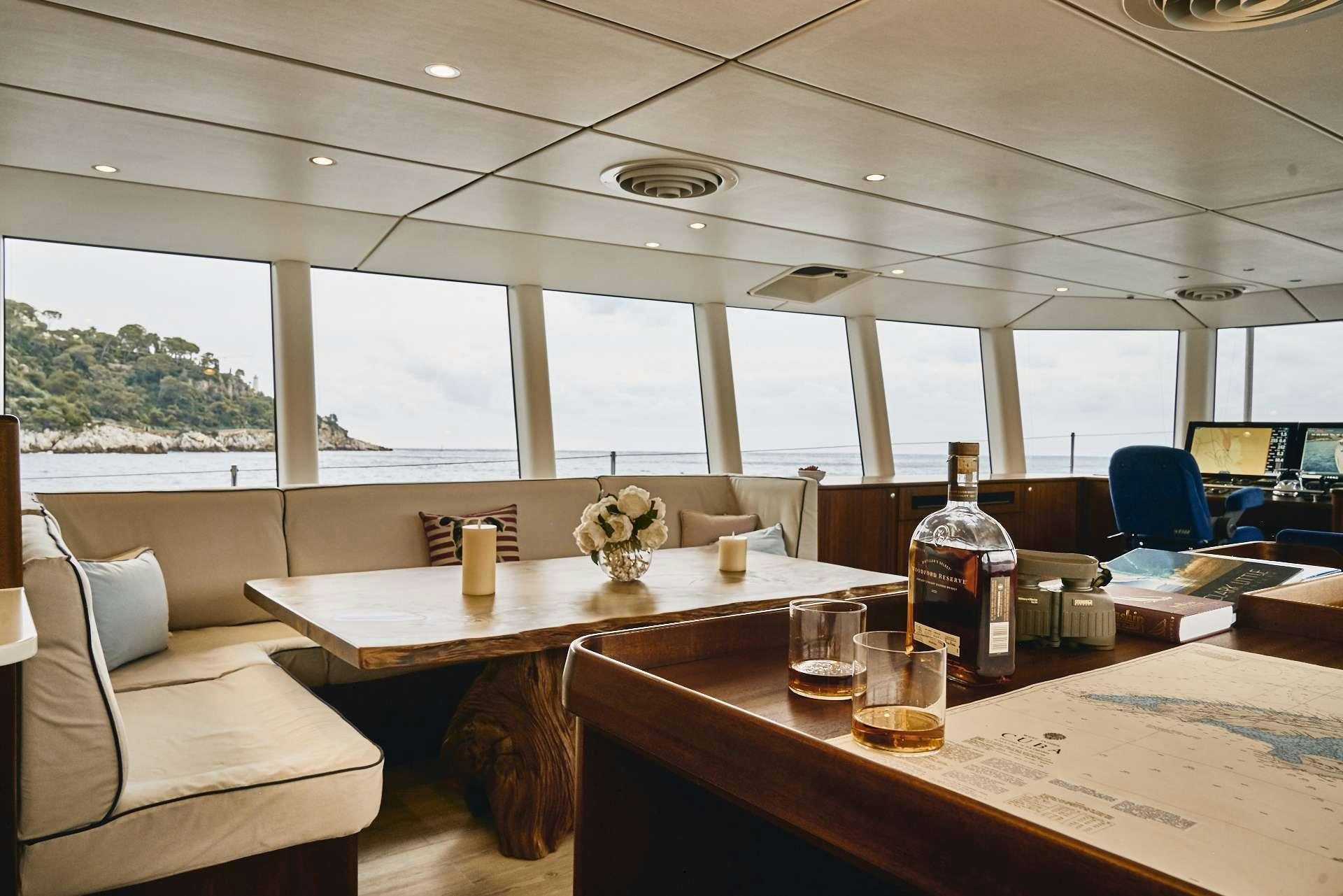 a table with glasses and bottles on it aboard ICEBERG Yacht for Charter
