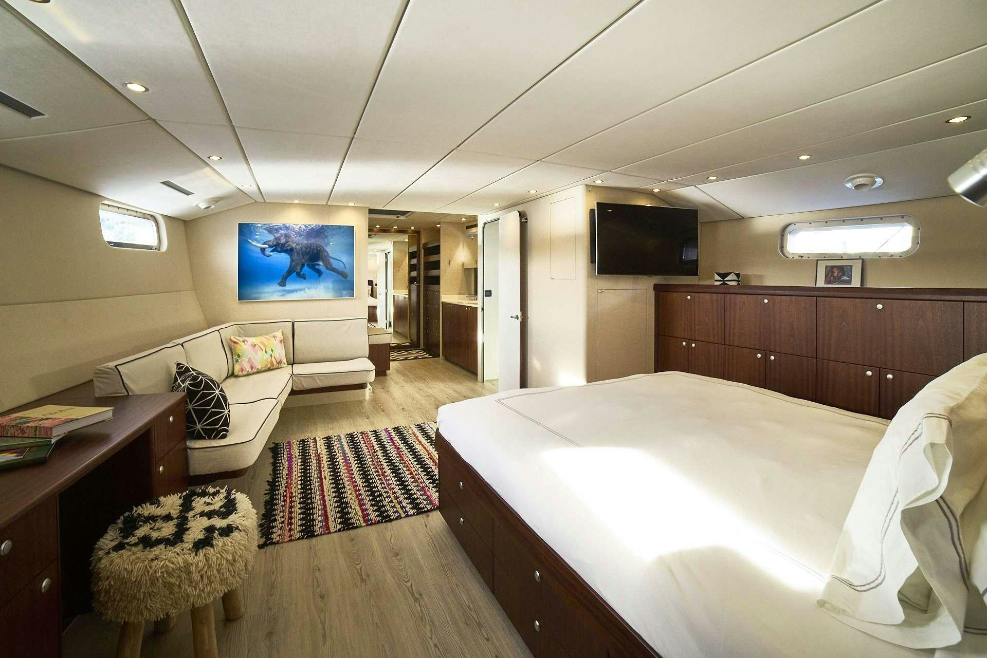 a bedroom with a bed and a tv aboard ICEBERG Yacht for Charter