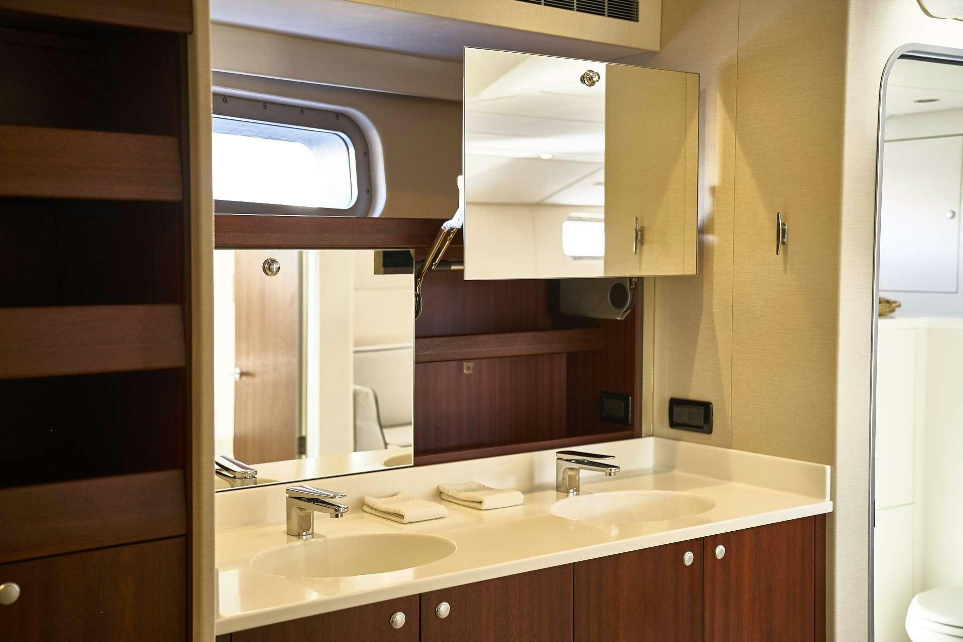 a bathroom with a sink and a mirror aboard ICEBERG Yacht for Charter