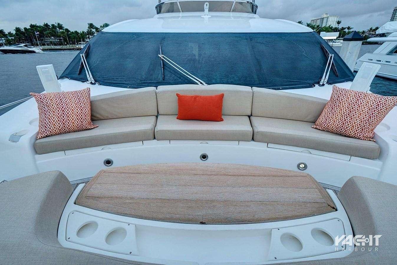 a white boat with red pillows aboard SPLASHED OUT Yacht for Charter