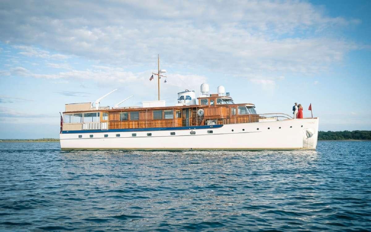 a large white and orange boat in the water aboard TIMELESS Yacht for Charter