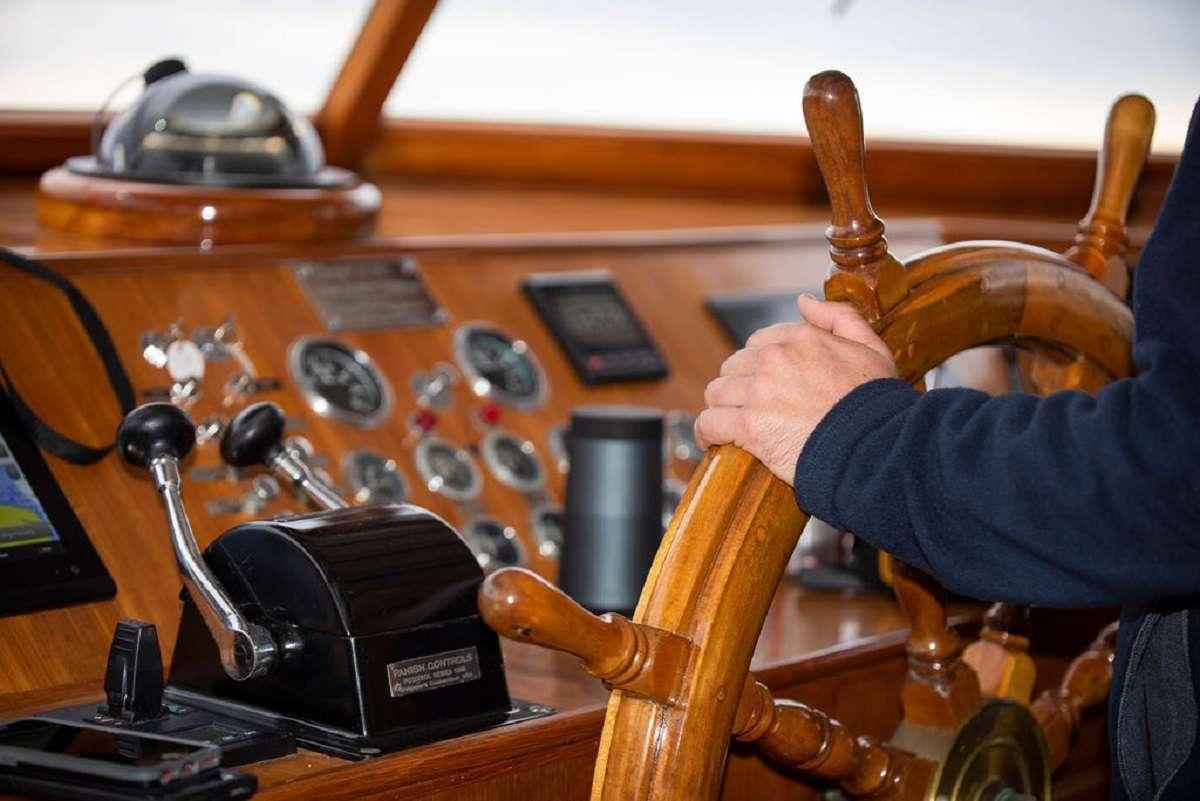 a person holding a wooden hammer aboard TIMELESS Yacht for Charter