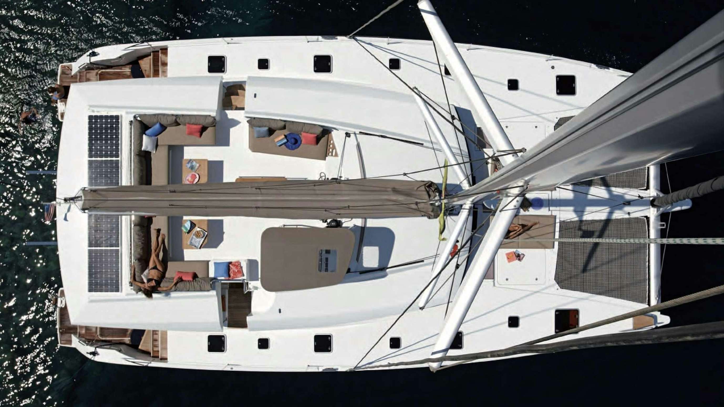 a white boat with a white sail aboard VIDA BOA II Yacht for Charter
