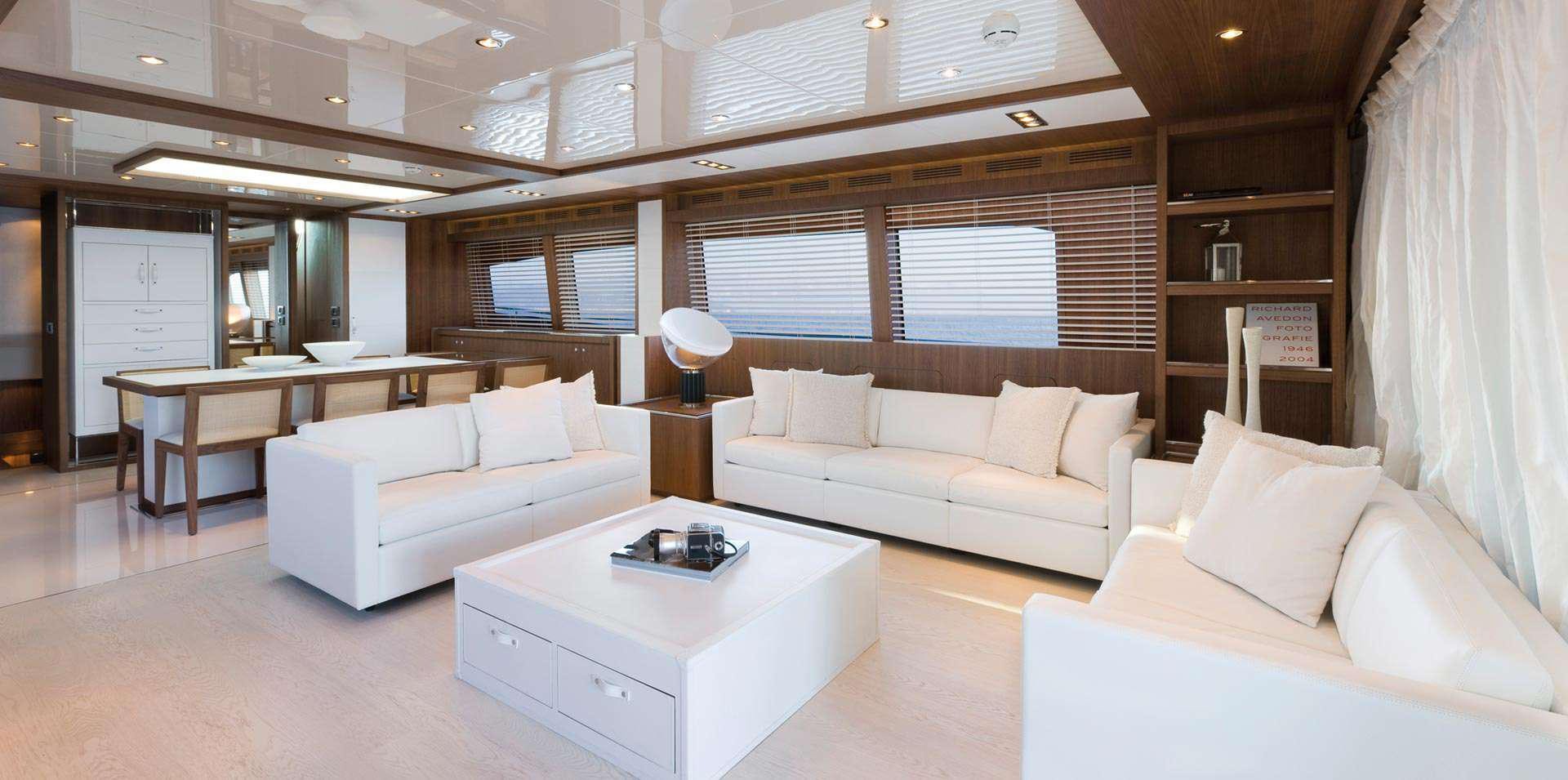 a room with a couch and a table aboard PRIVILEGIO Yacht for Charter