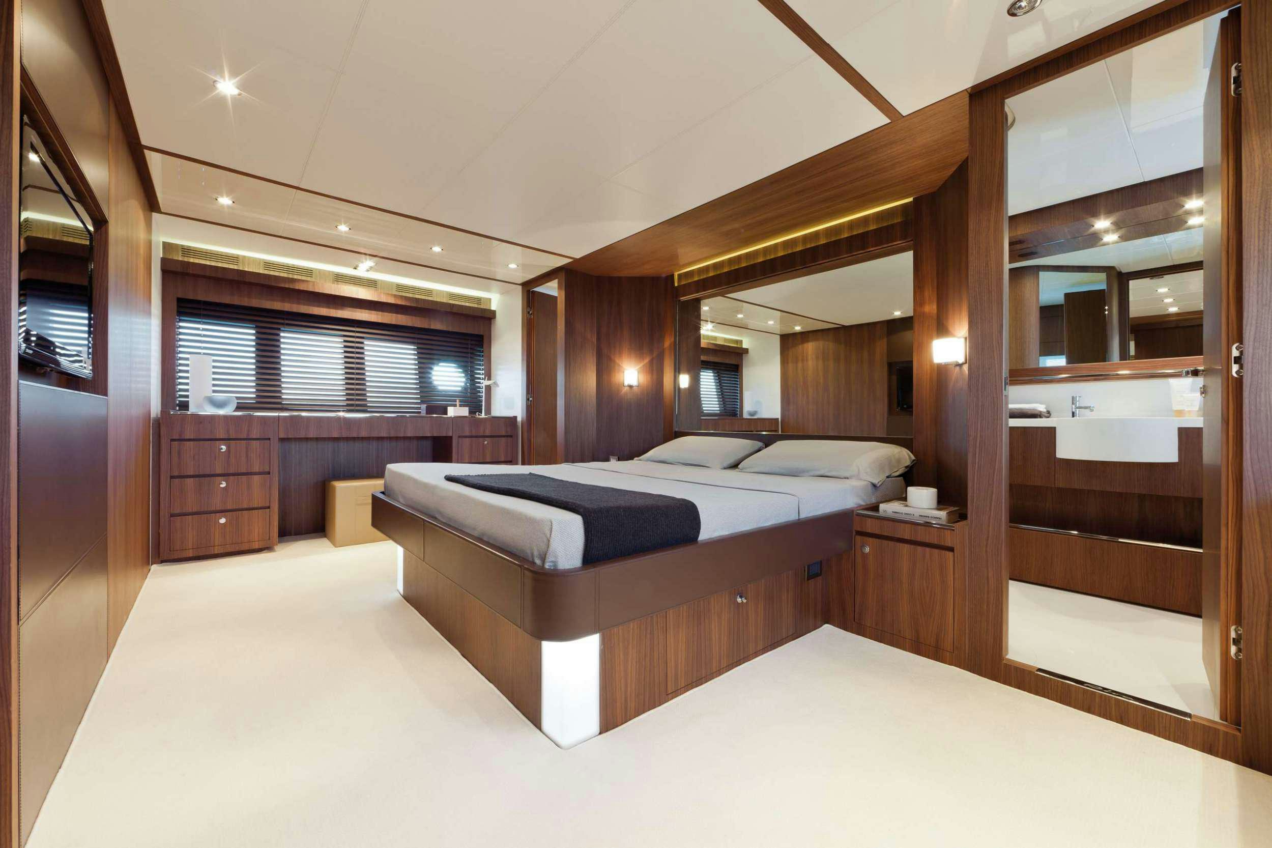 a large bedroom with a bed aboard PRIVILEGIO Yacht for Charter