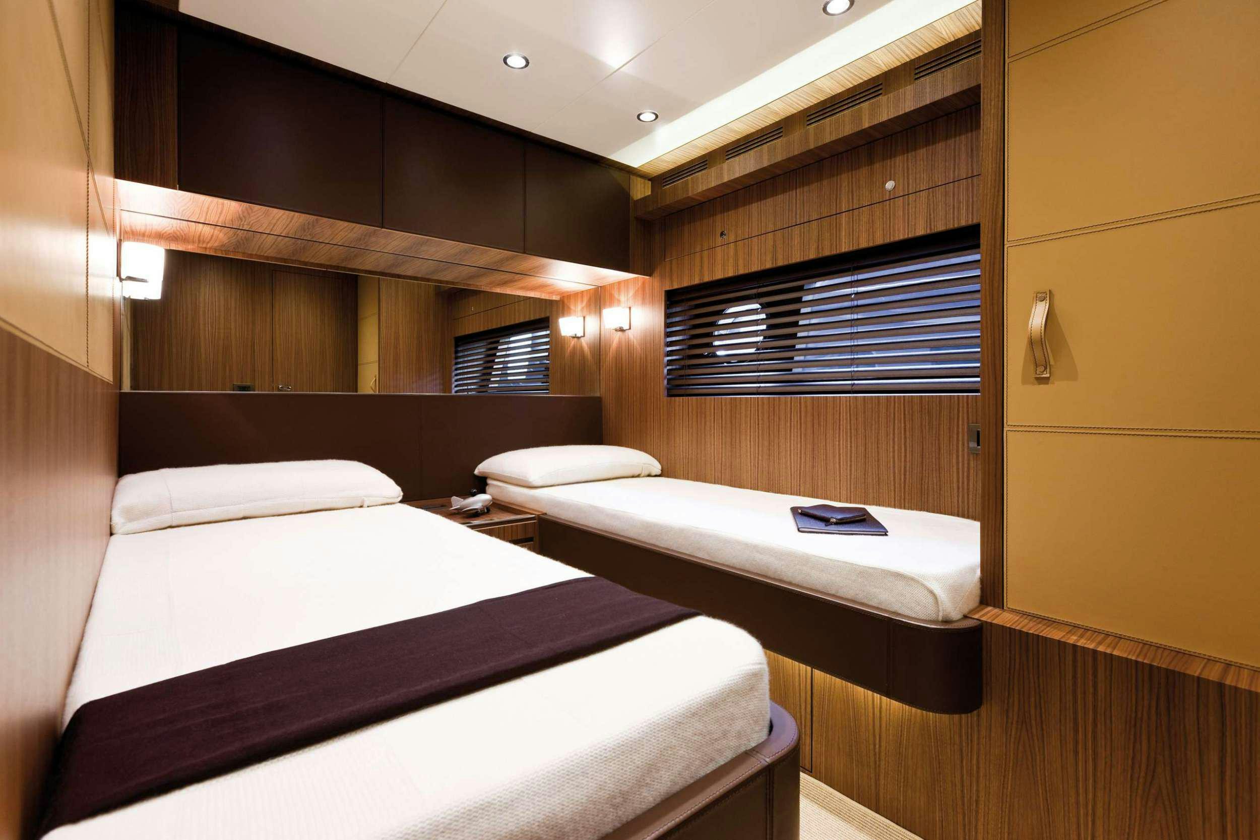 a room with two beds aboard PRIVILEGIO Yacht for Charter