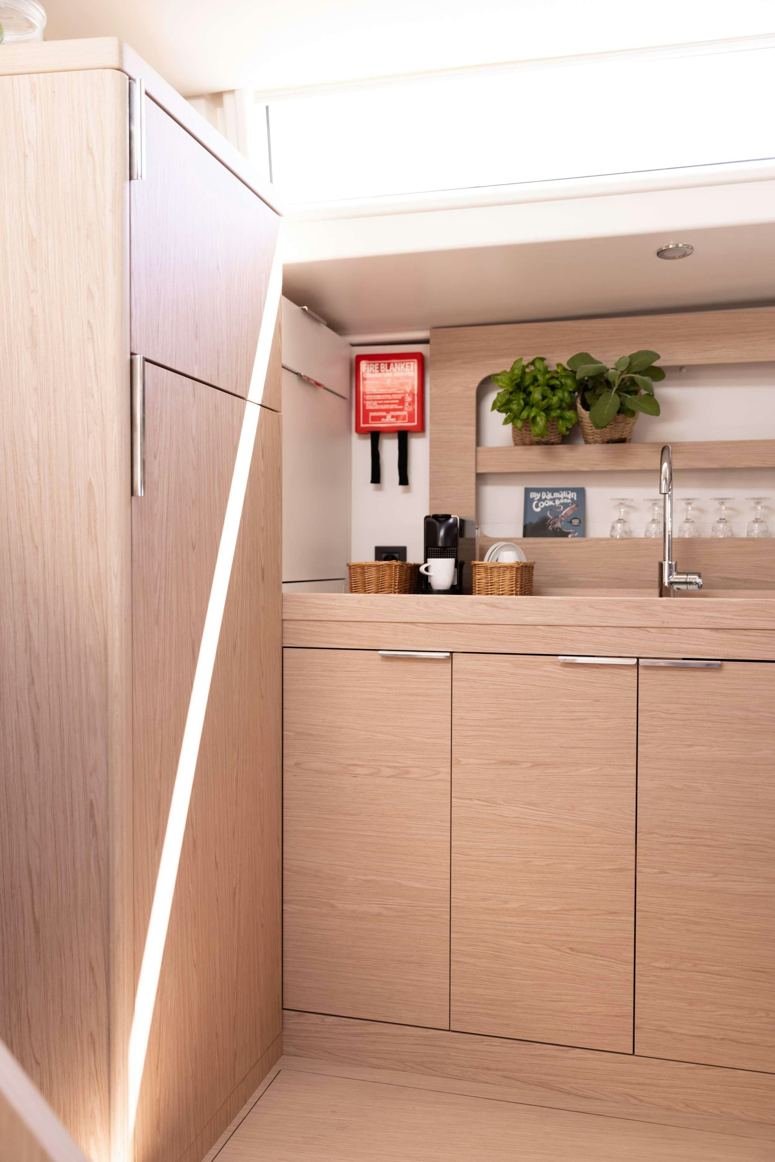 a kitchen with wooden cabinets aboard WHITE BIRD Yacht for Charter