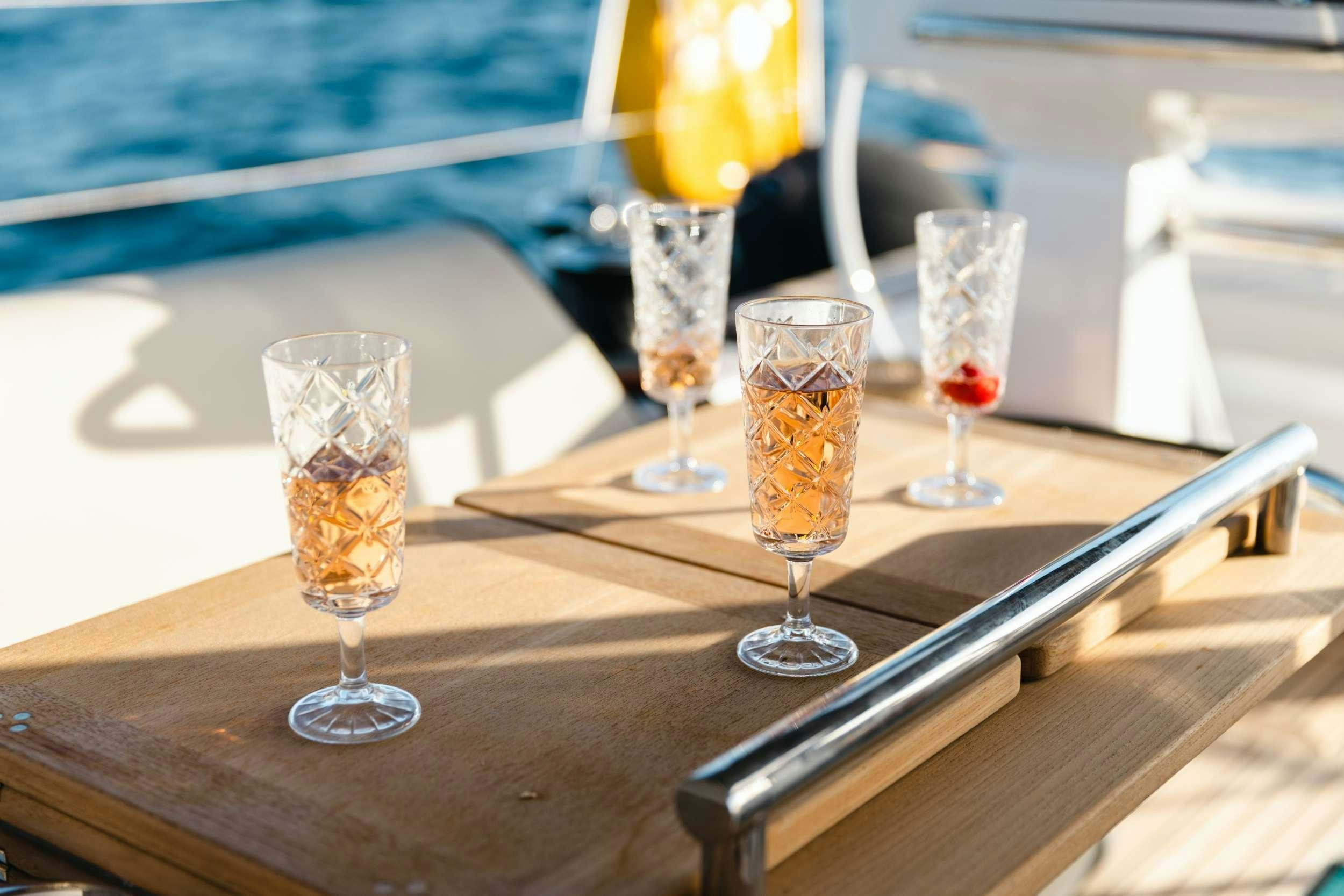 a group of glasses of beer on a table aboard WHITE BIRD Yacht for Charter