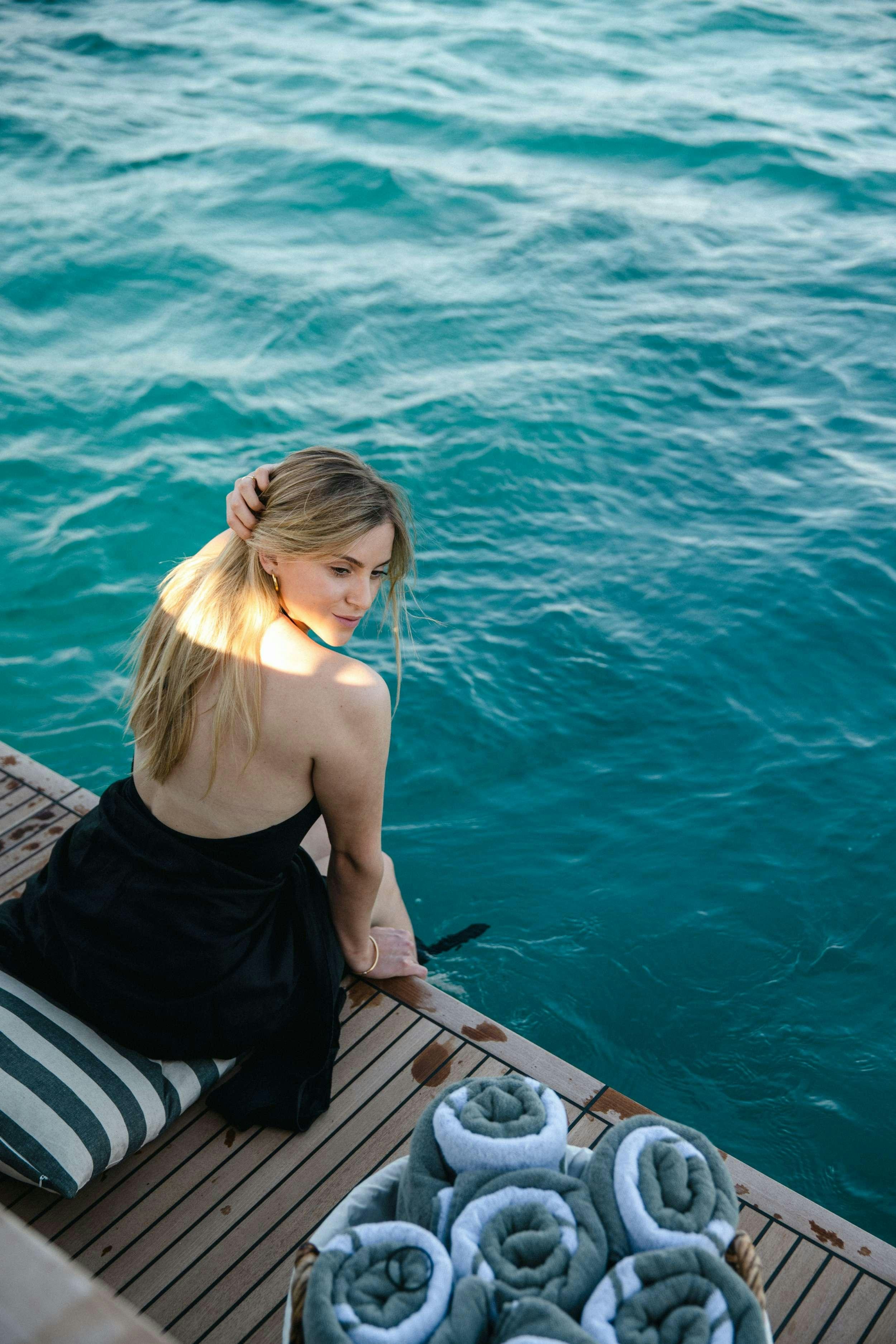 a person leaning on a boat aboard WHITE BIRD Yacht for Charter