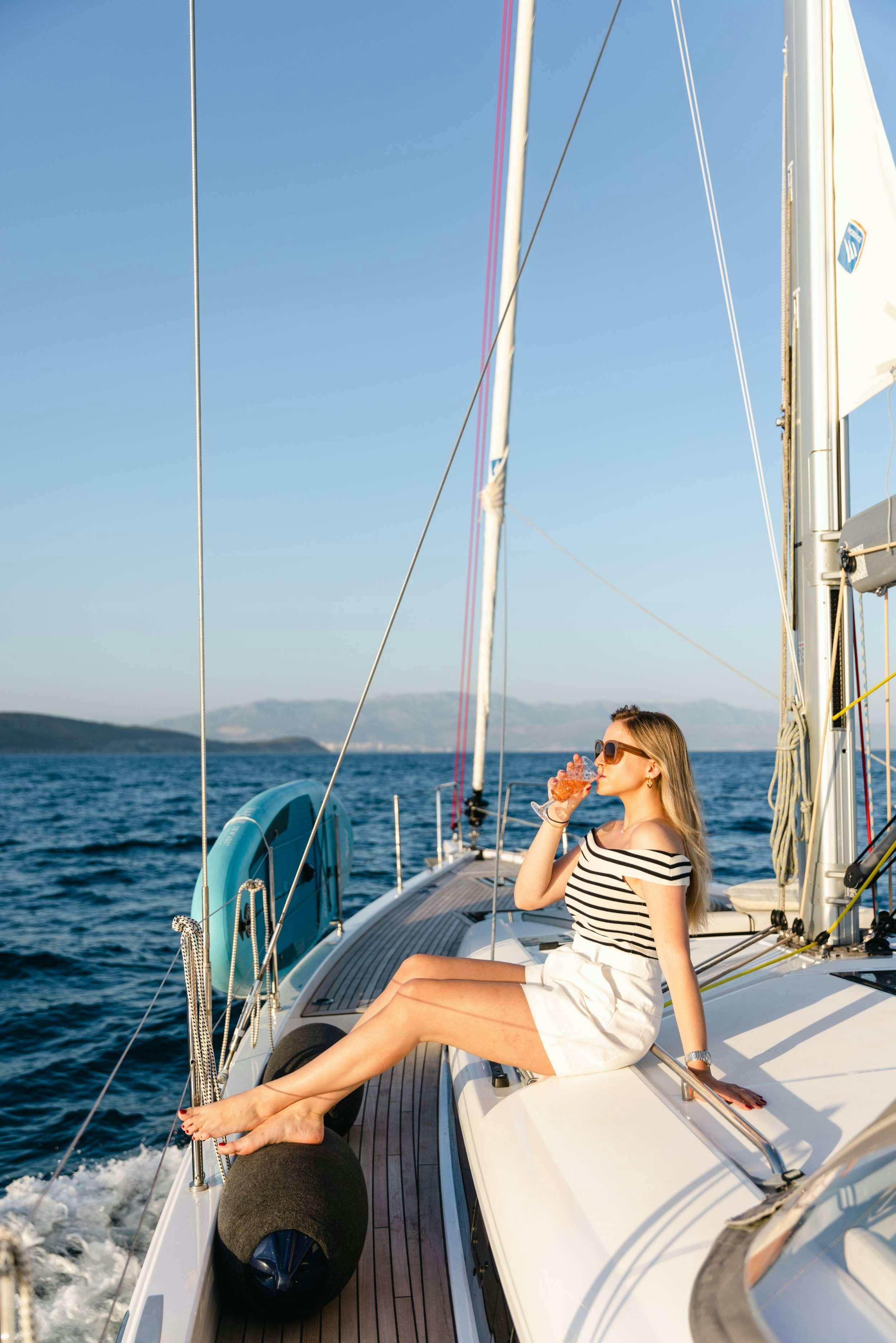 a person sitting on a boat aboard WHITE BIRD Yacht for Charter