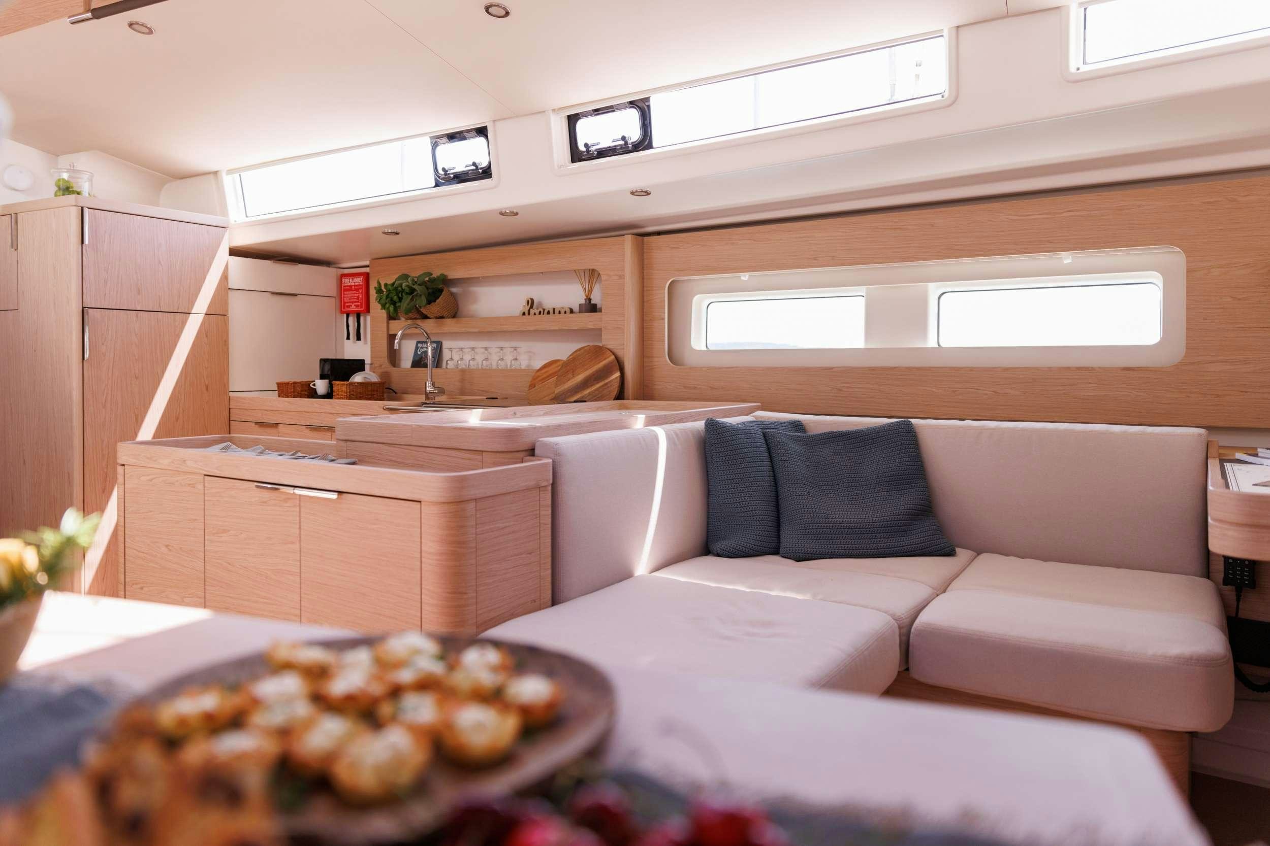 a white couch in a room aboard WHITE BIRD Yacht for Charter