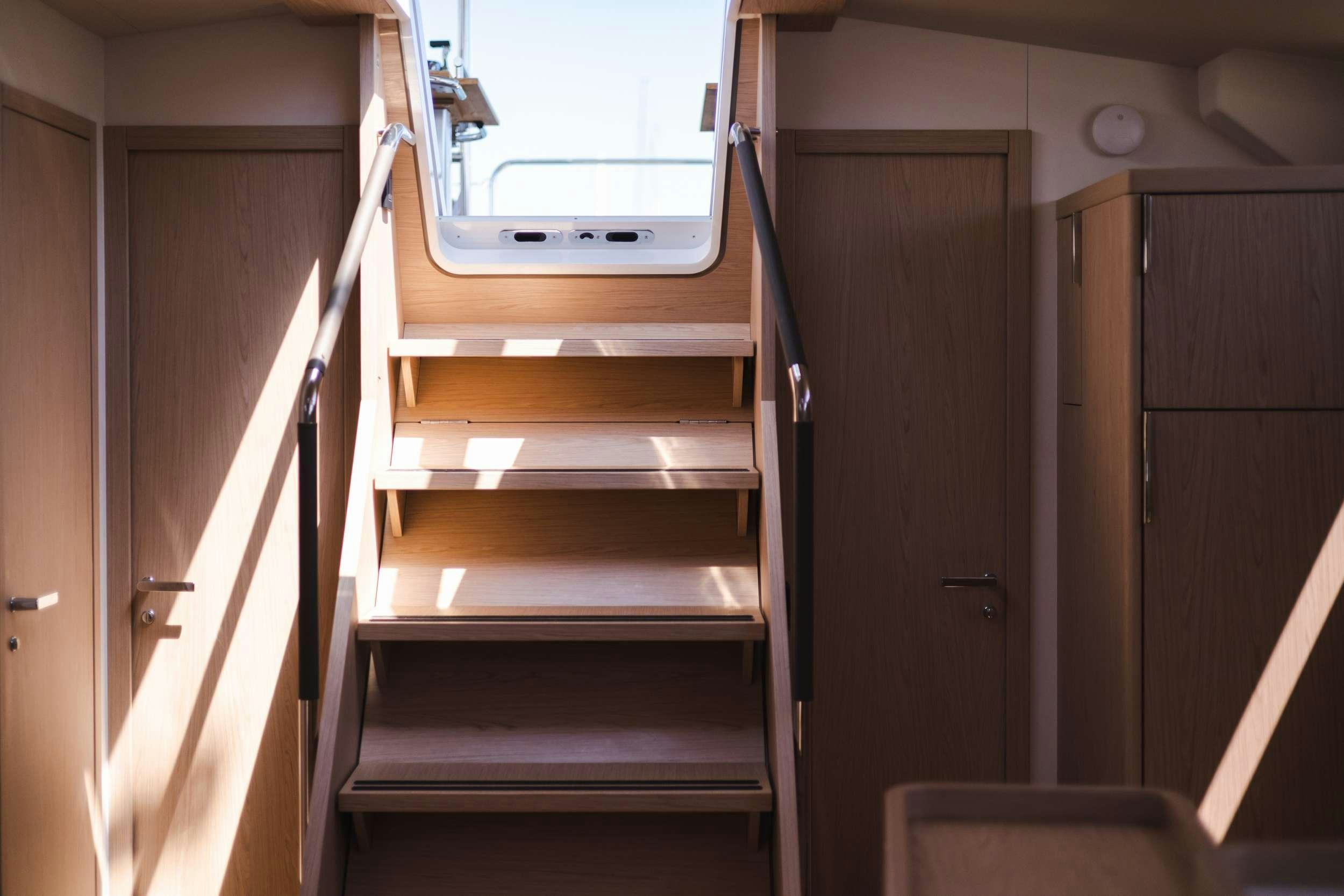 a wooden staircase in a room aboard WHITE BIRD Yacht for Charter