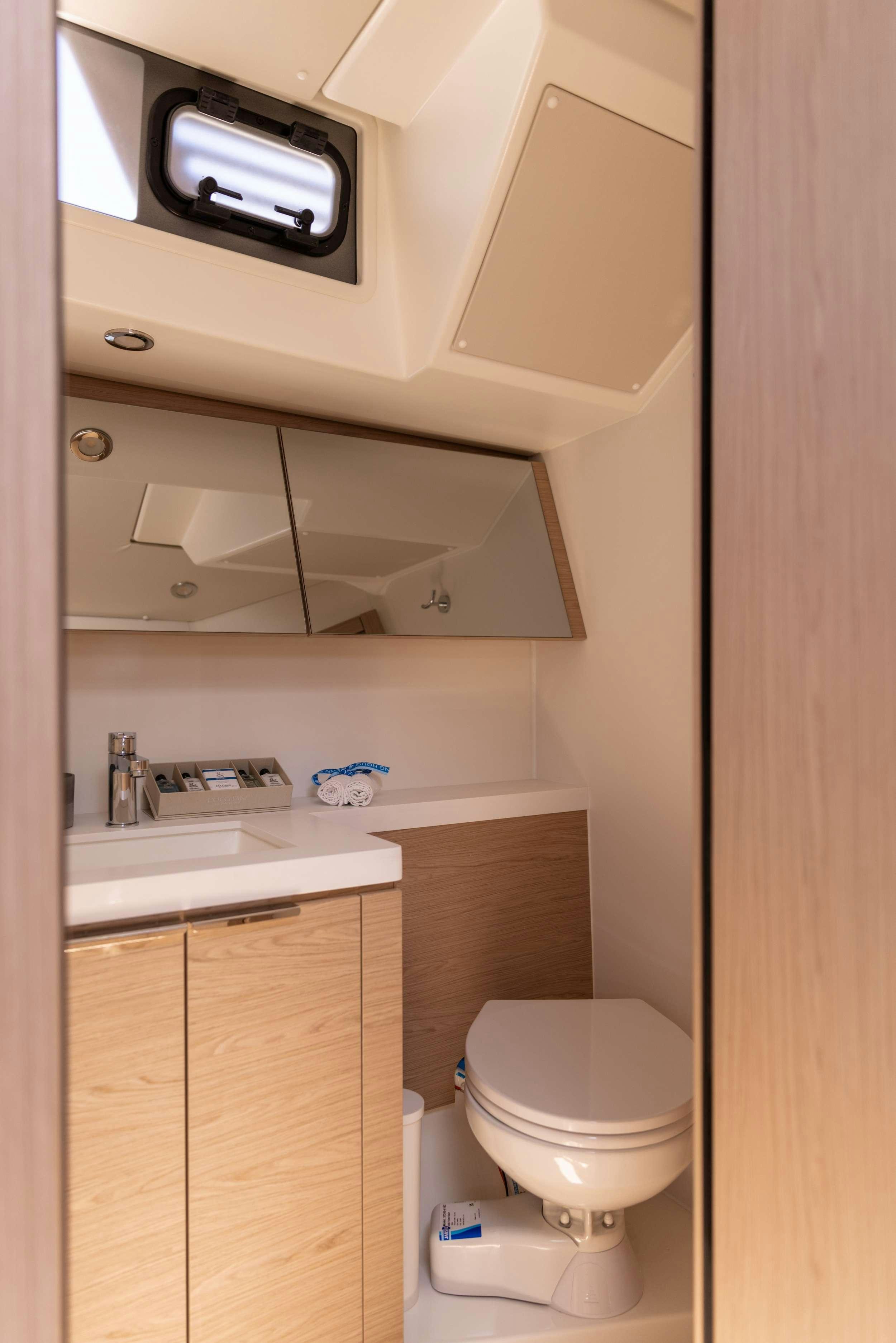 a small bathroom with a toilet and sink aboard WHITE BIRD Yacht for Charter