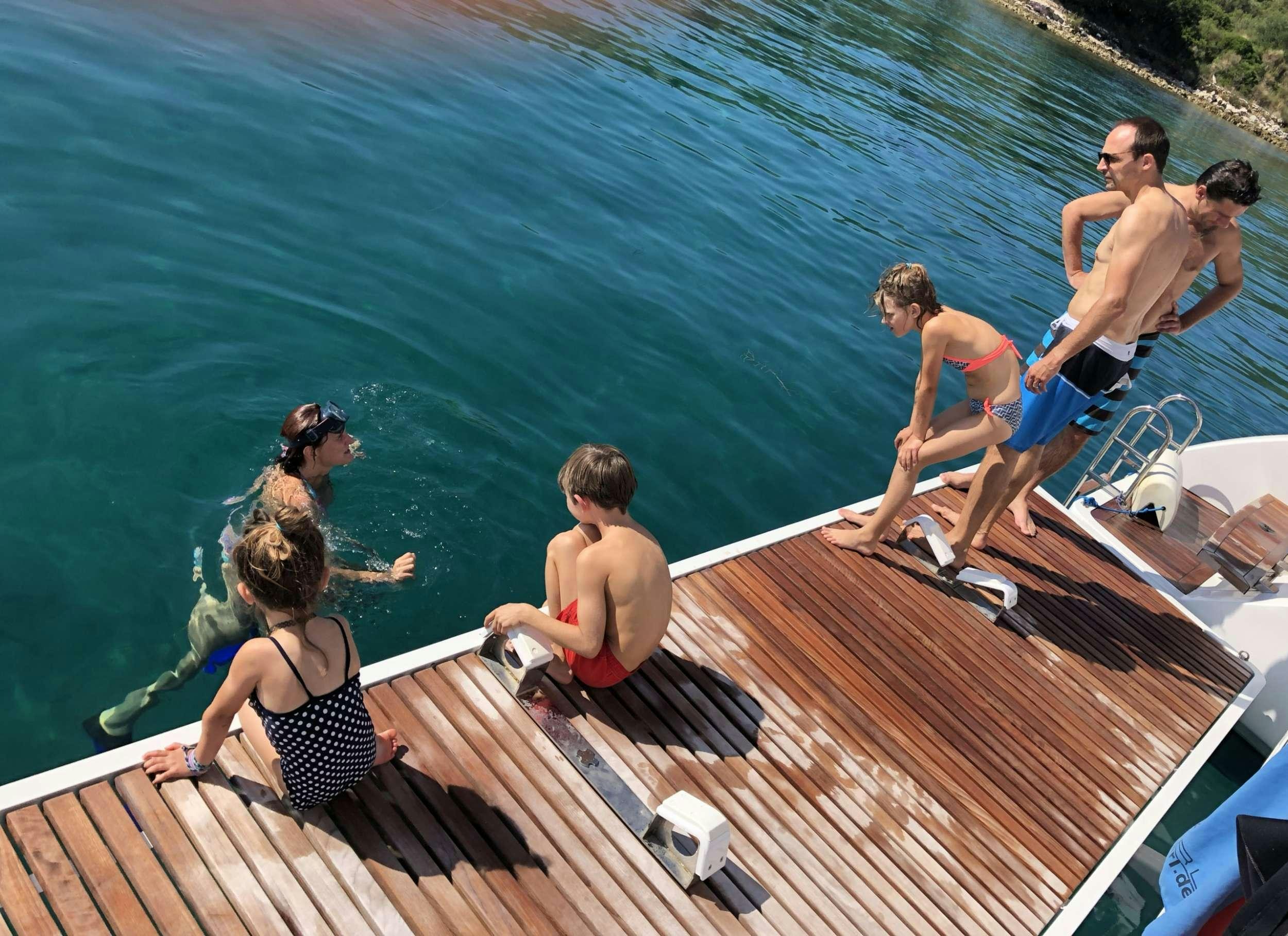 a group of people on a dock aboard TIRIL Yacht for Charter