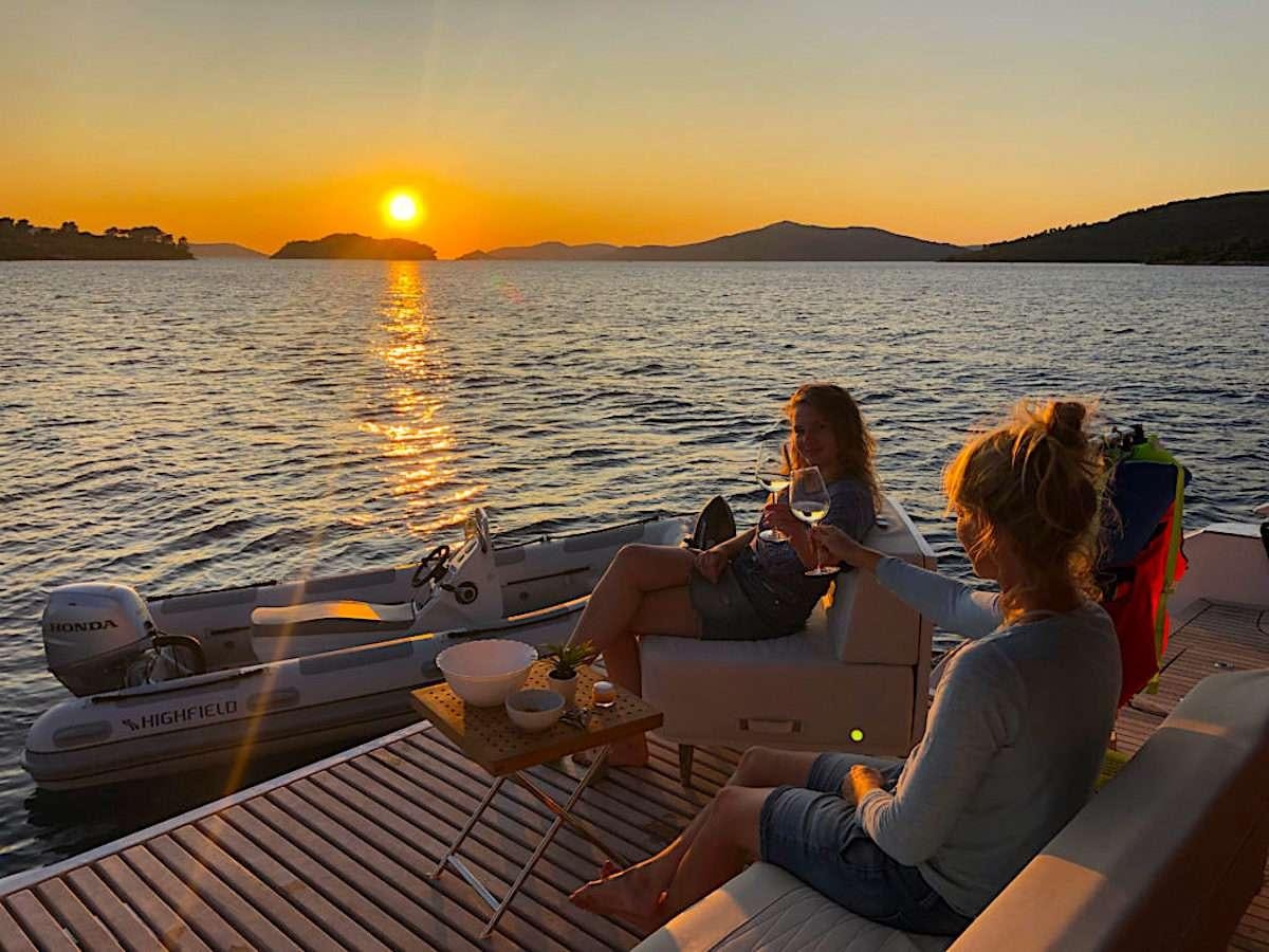 a group of women sitting on a boat on the water aboard TIRIL Yacht for Charter
