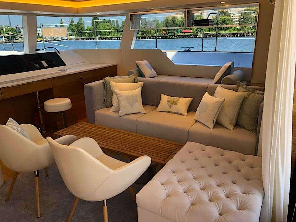 a living room with a couch and a table aboard TIRIL Yacht for Charter