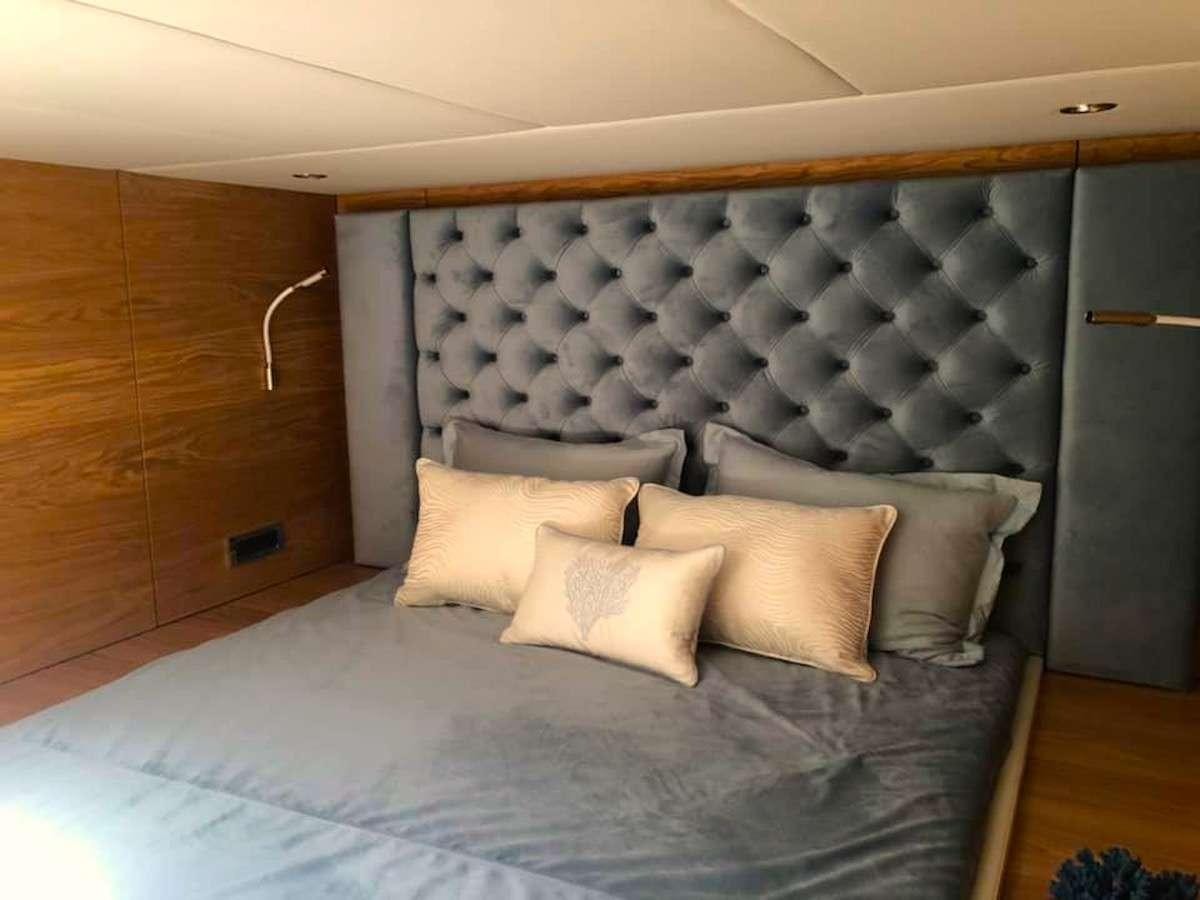 a bed with pillows aboard TIRIL Yacht for Charter