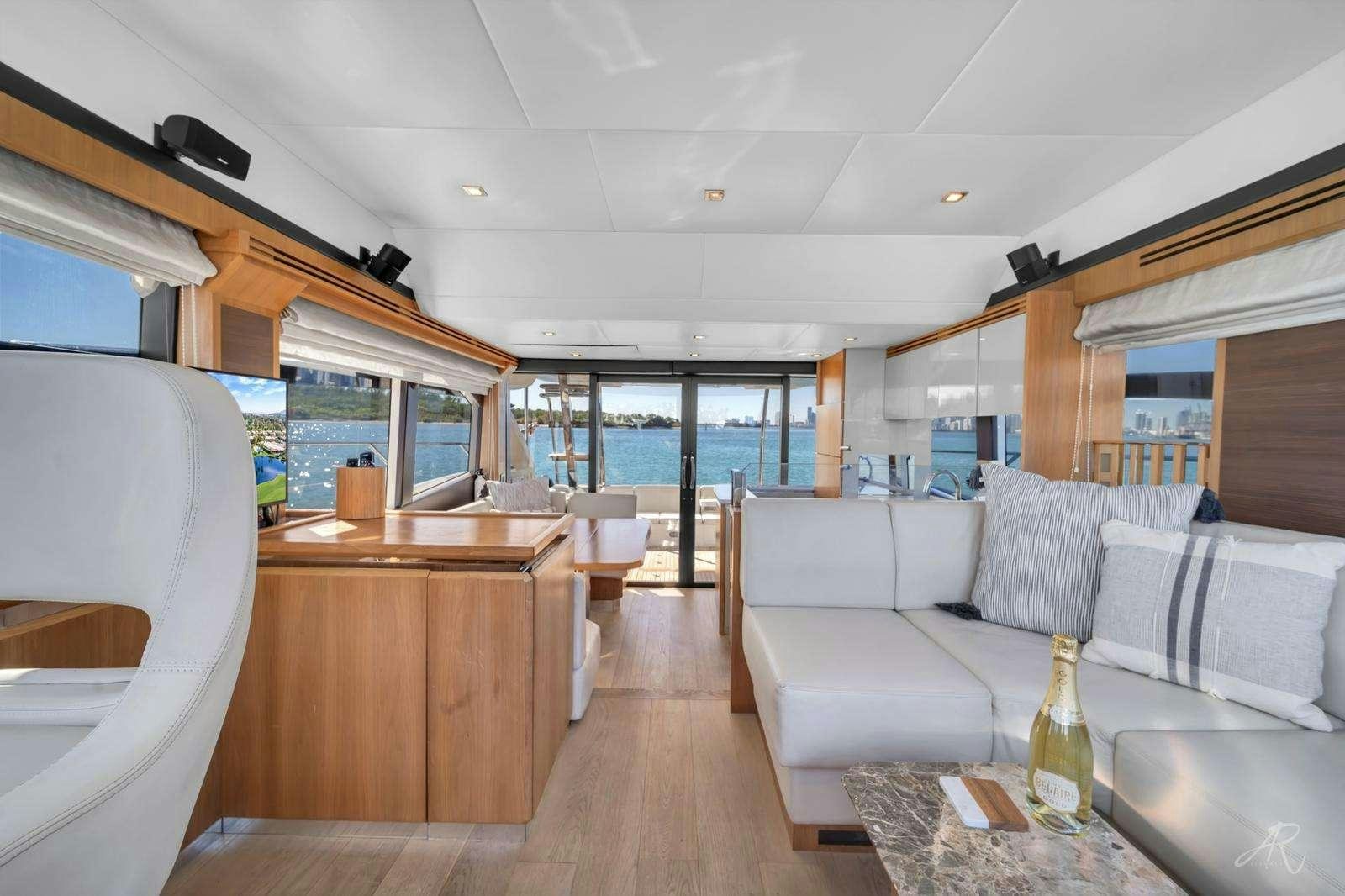 a living room with a glass bottle aboard TWO Yacht for Charter