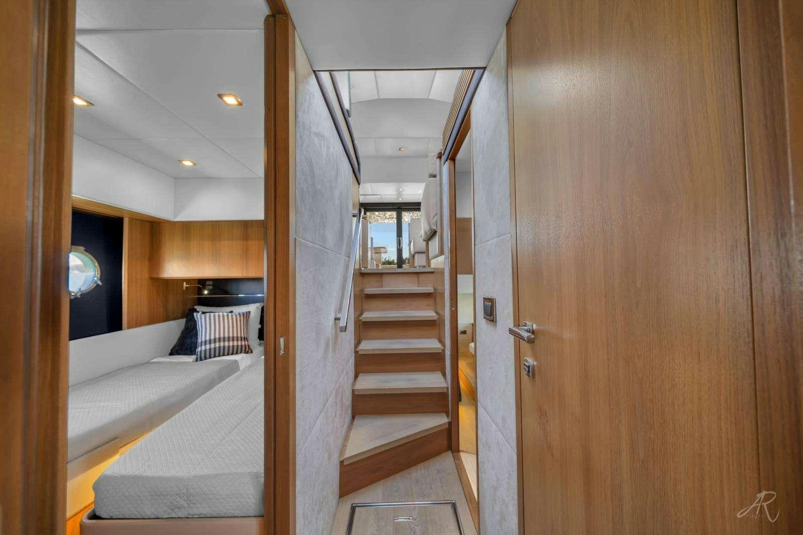 a room with a bed and a door aboard TWO Yacht for Charter