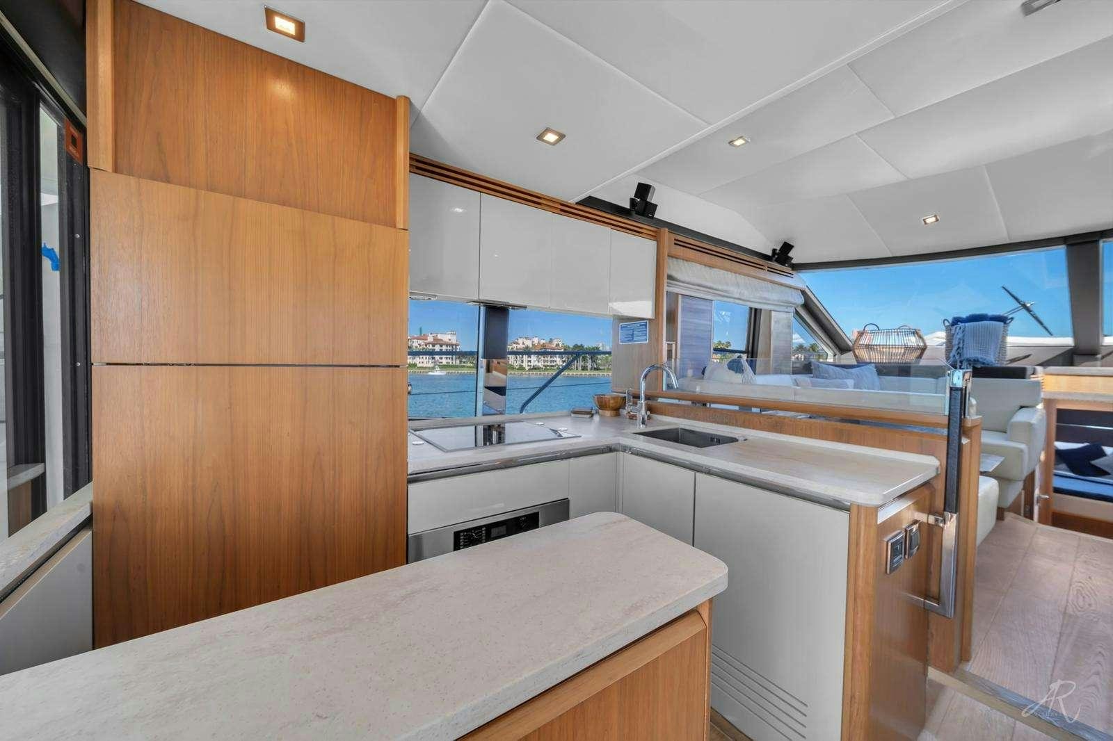 a kitchen with a large island aboard TWO Yacht for Charter