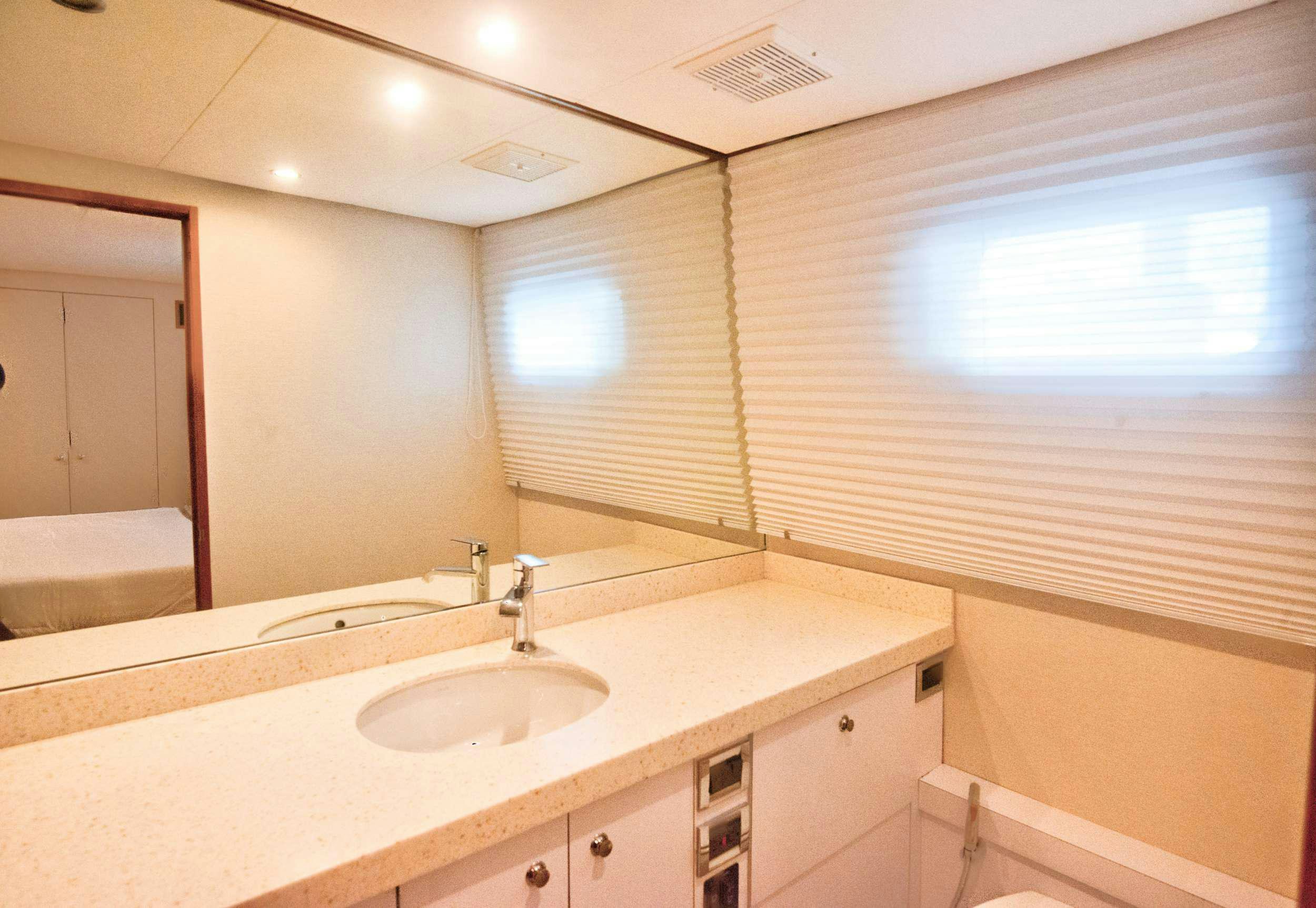 a bathroom with a sink and a mirror aboard DESLIZE Yacht for Charter