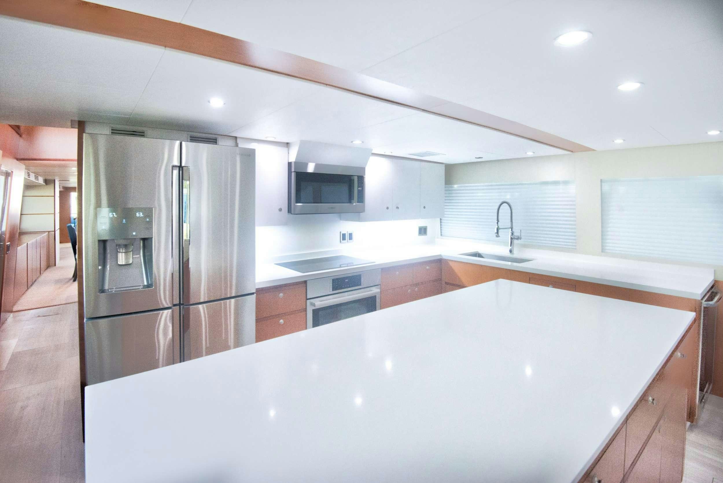 a kitchen with a large island aboard DESLIZE Yacht for Charter