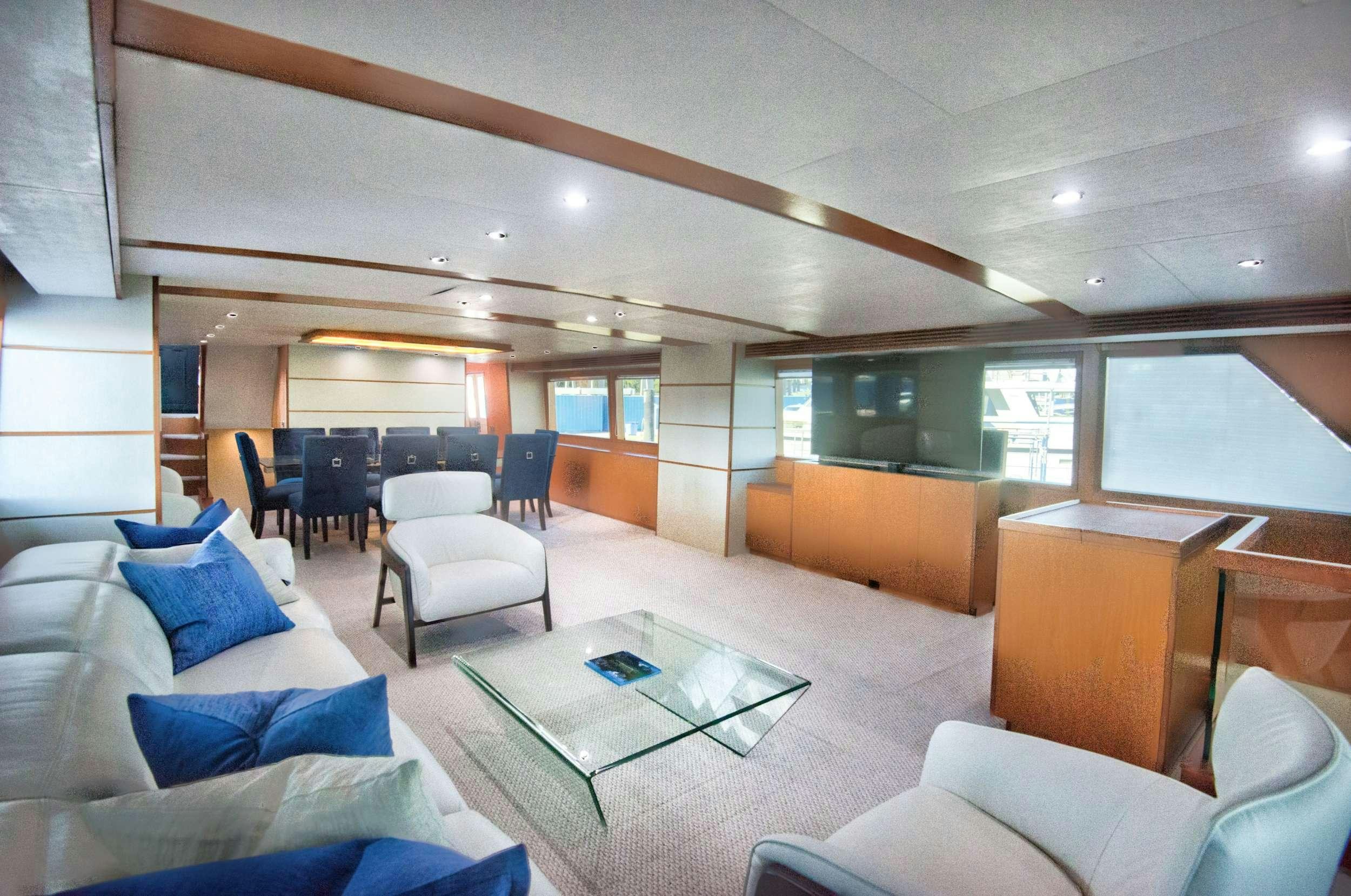 a room with a couch and a table and chairs aboard DESLIZE Yacht for Charter