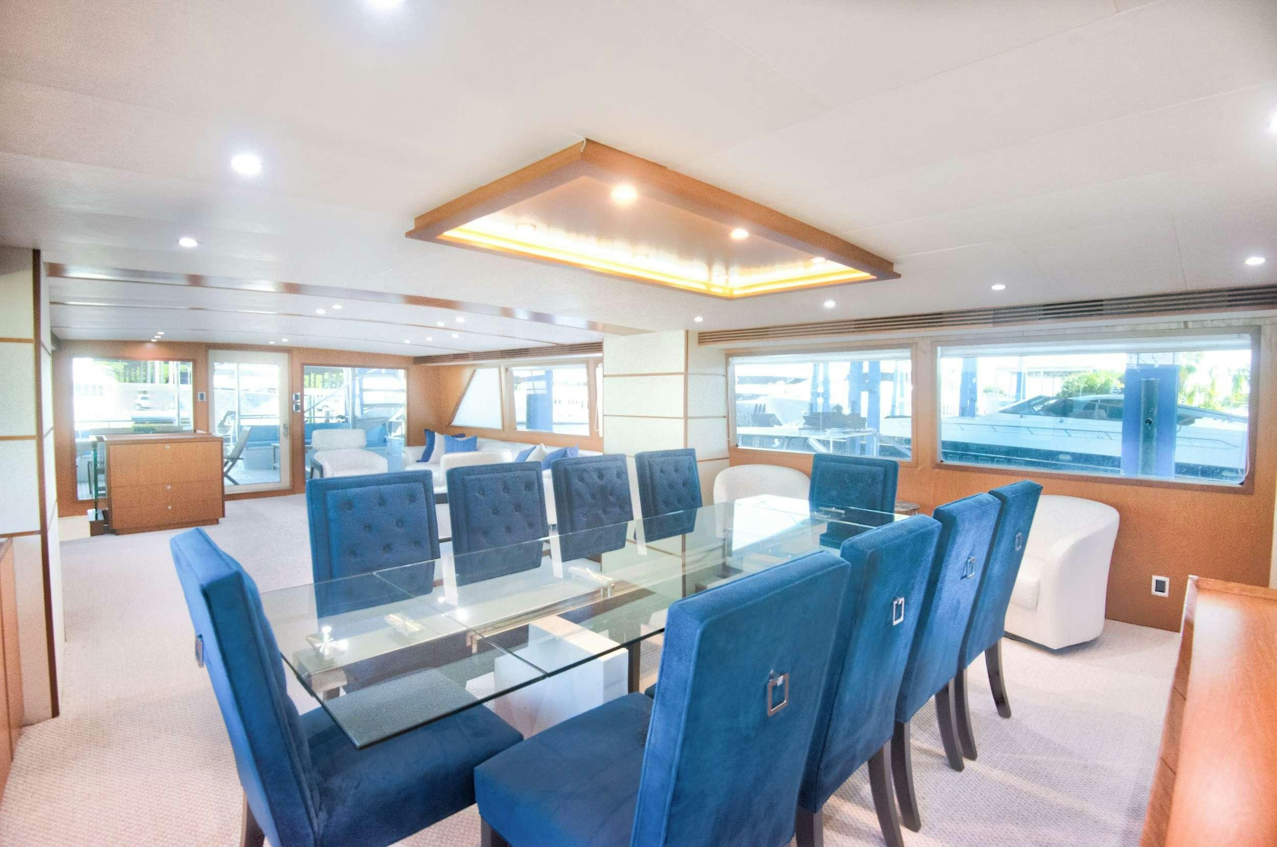 a room with a table chairs and a laptop aboard DESLIZE Yacht for Charter