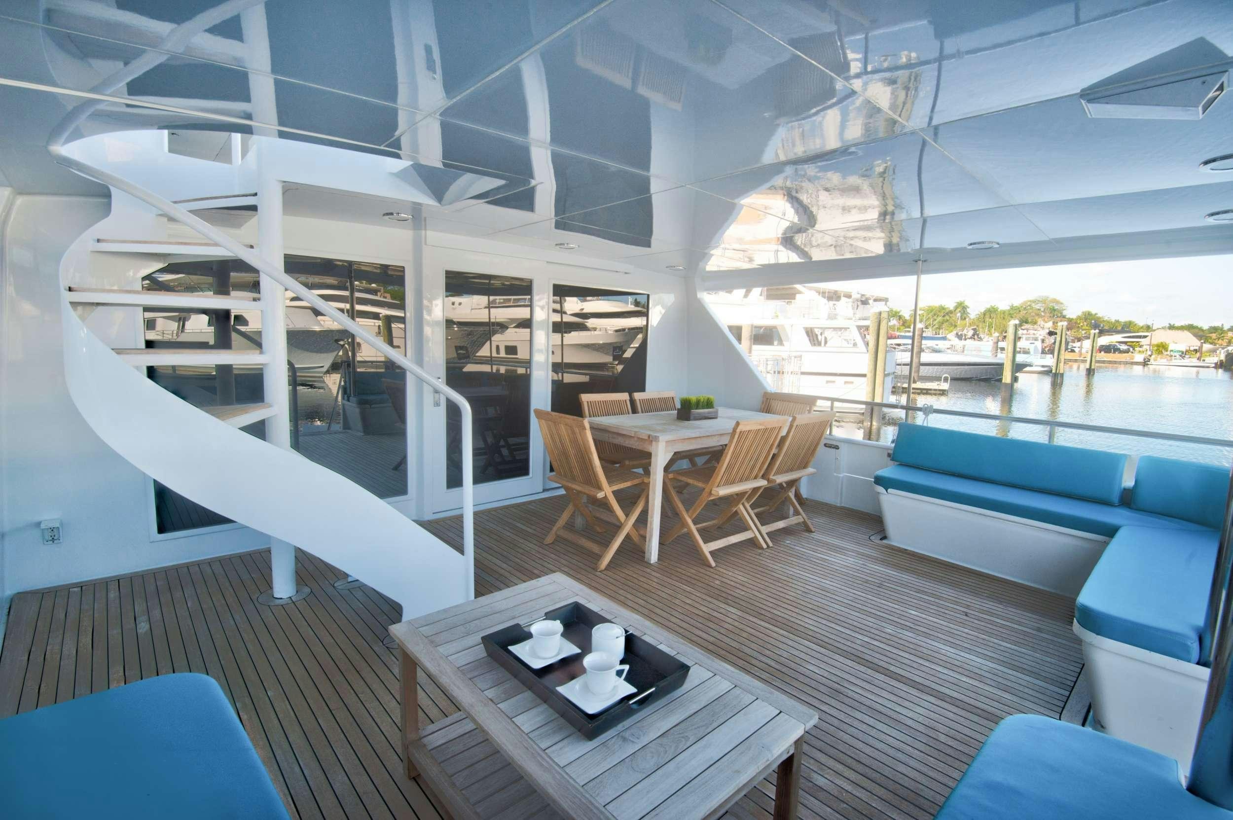 a boat with a table and chairs aboard DESLIZE Yacht for Charter