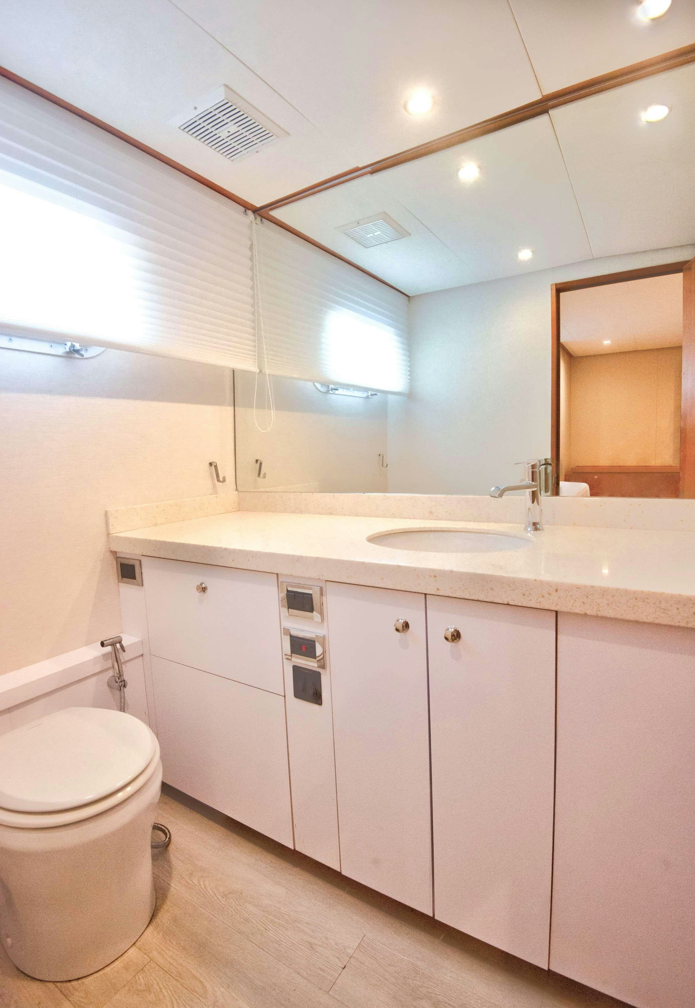 a bathroom with a sink and toilet aboard DESLIZE Yacht for Charter
